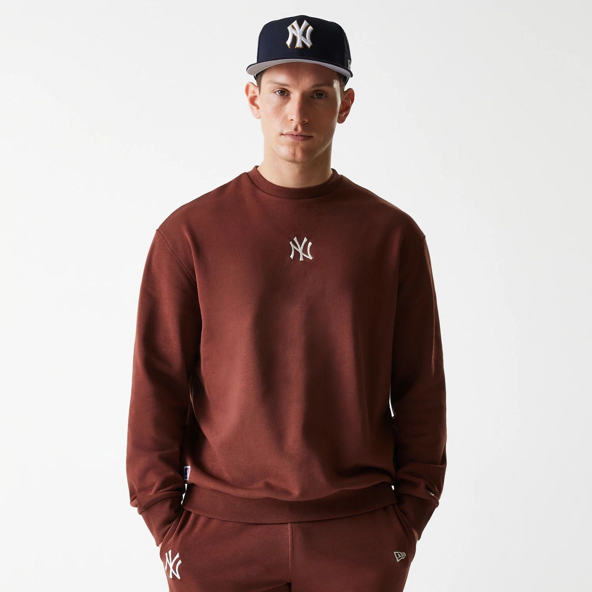 The Male model is wearing New York Yankees MLB Midi League Essential Brown Oversized Crew Neck Sweater 1