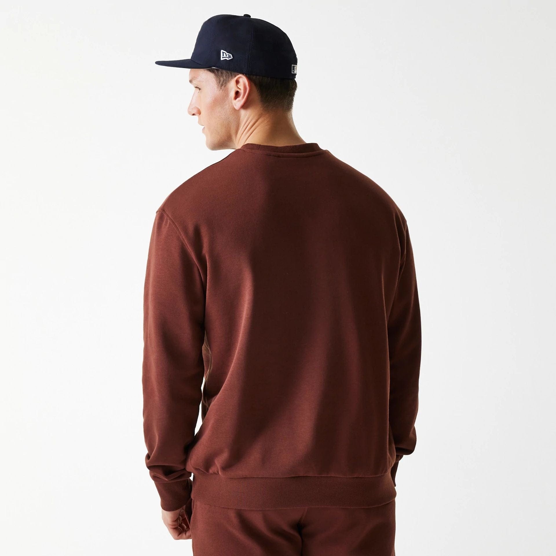 The Male model is wearing New York Yankees MLB Midi League Essential Brown Oversized Crew Neck Sweater 2