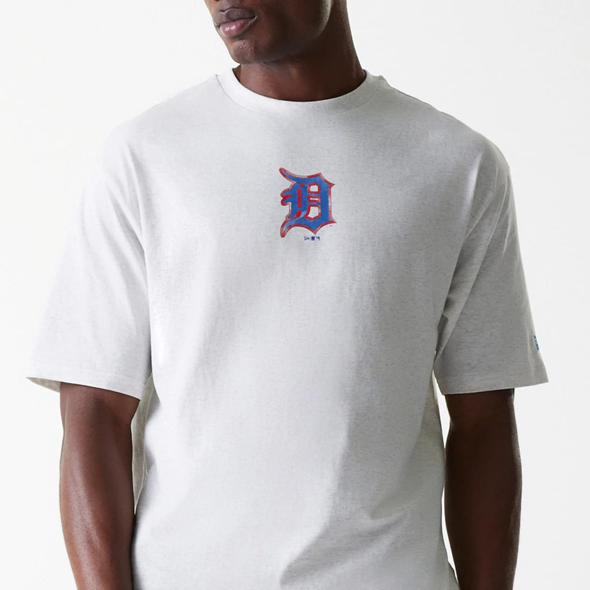 New Era Detroit Tigers MLB World Series Pastel Grey Oversized T-Shirt, front view showing the grey fabric with a large blue and orange Detroit Tigers logo centred on the chest and a small logo patch on the left sleeve.