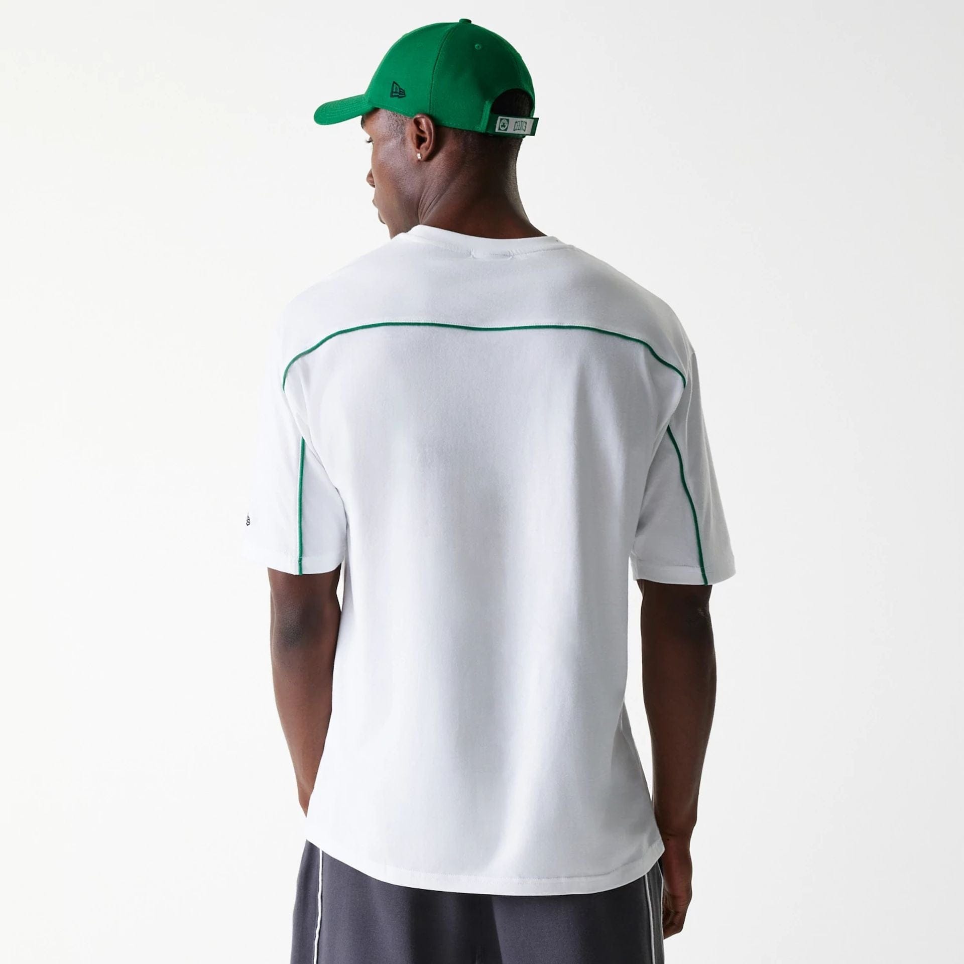 The Male model is wearing Boston Celtics NBA Piping White Oversized T-Shirt 2
