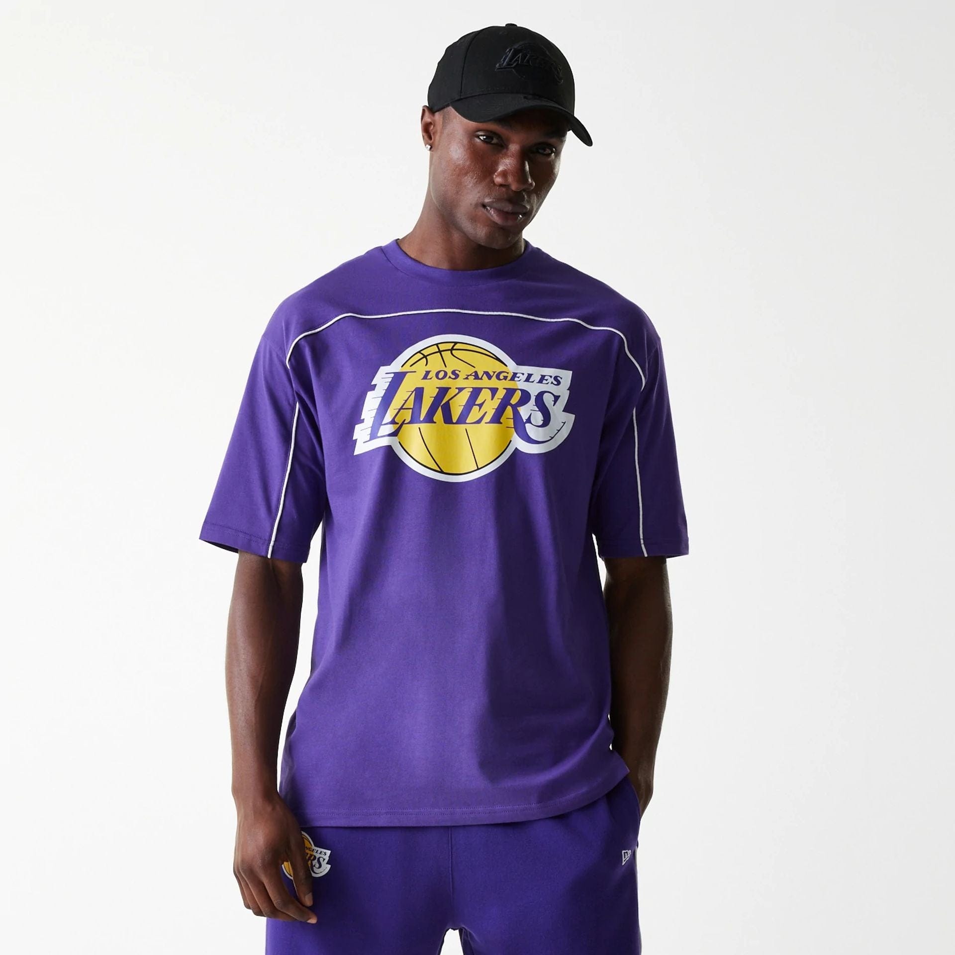 The Male model is wearing LA Lakers NBA Piping Purple Oversized T-Shirt 1