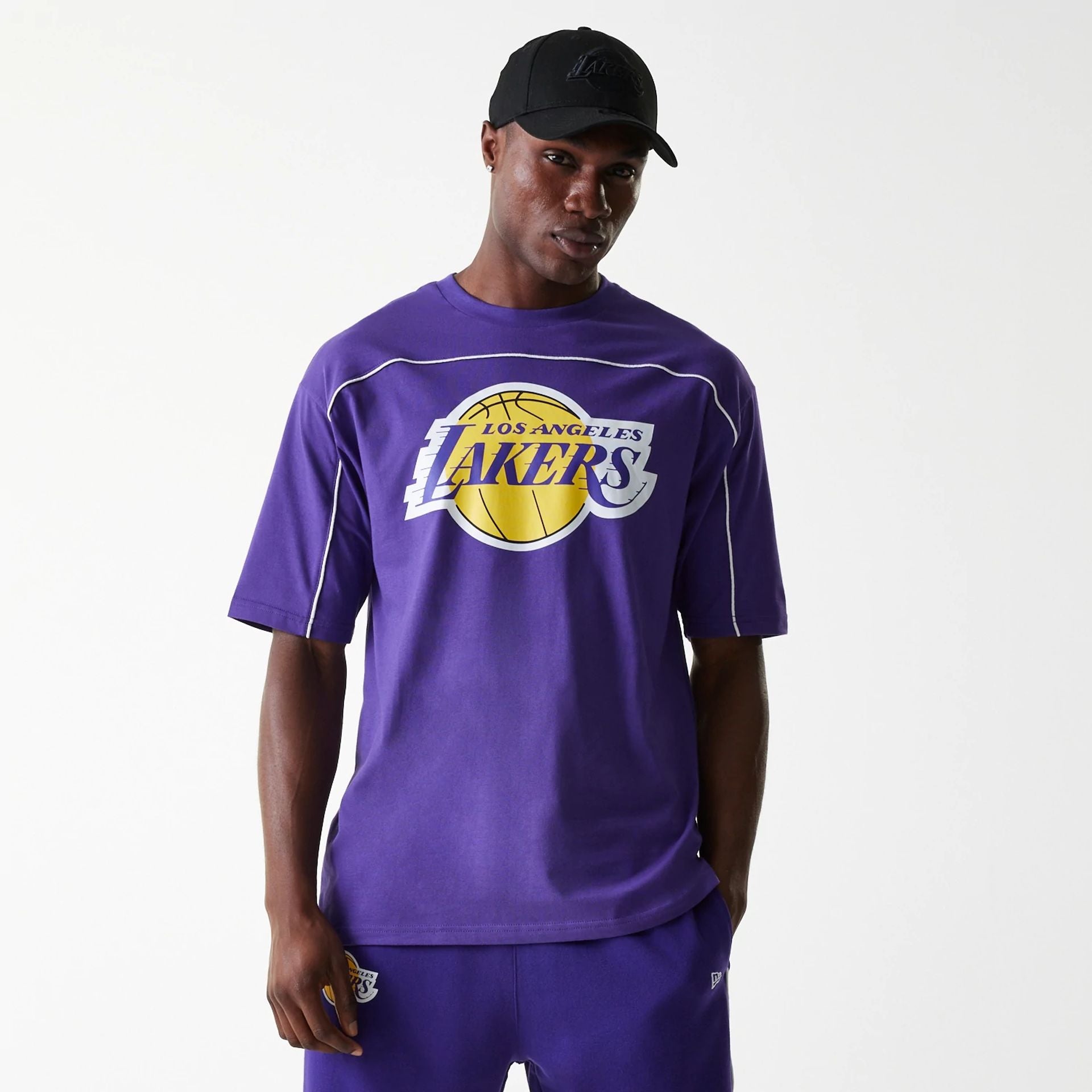 The Male model is wearing LA Lakers NBA Piping Purple Oversized T-Shirt 1