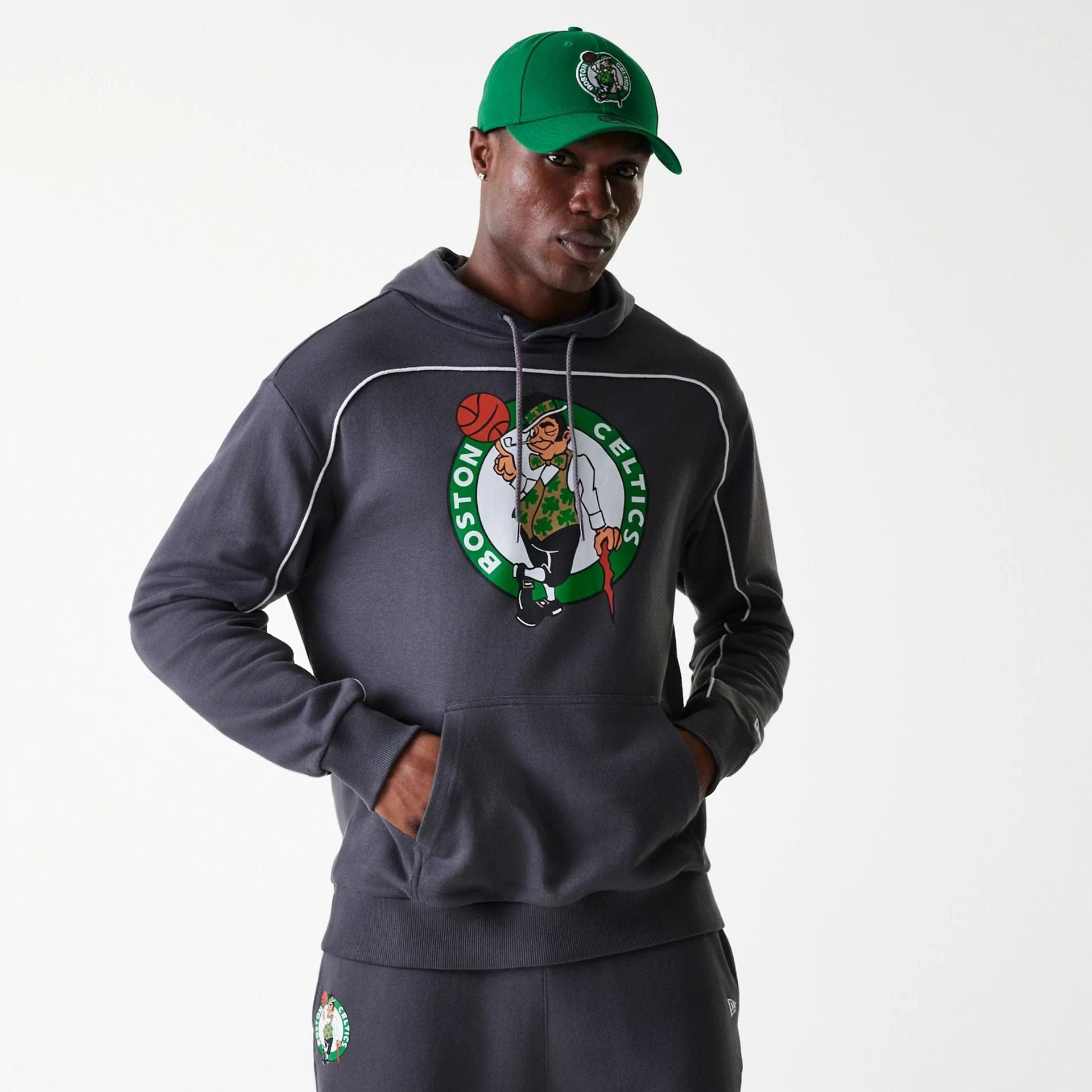 The Male model is wearing Boston Celtics NBA Piping Dark Grey Oversized Pullover Hoodie 1