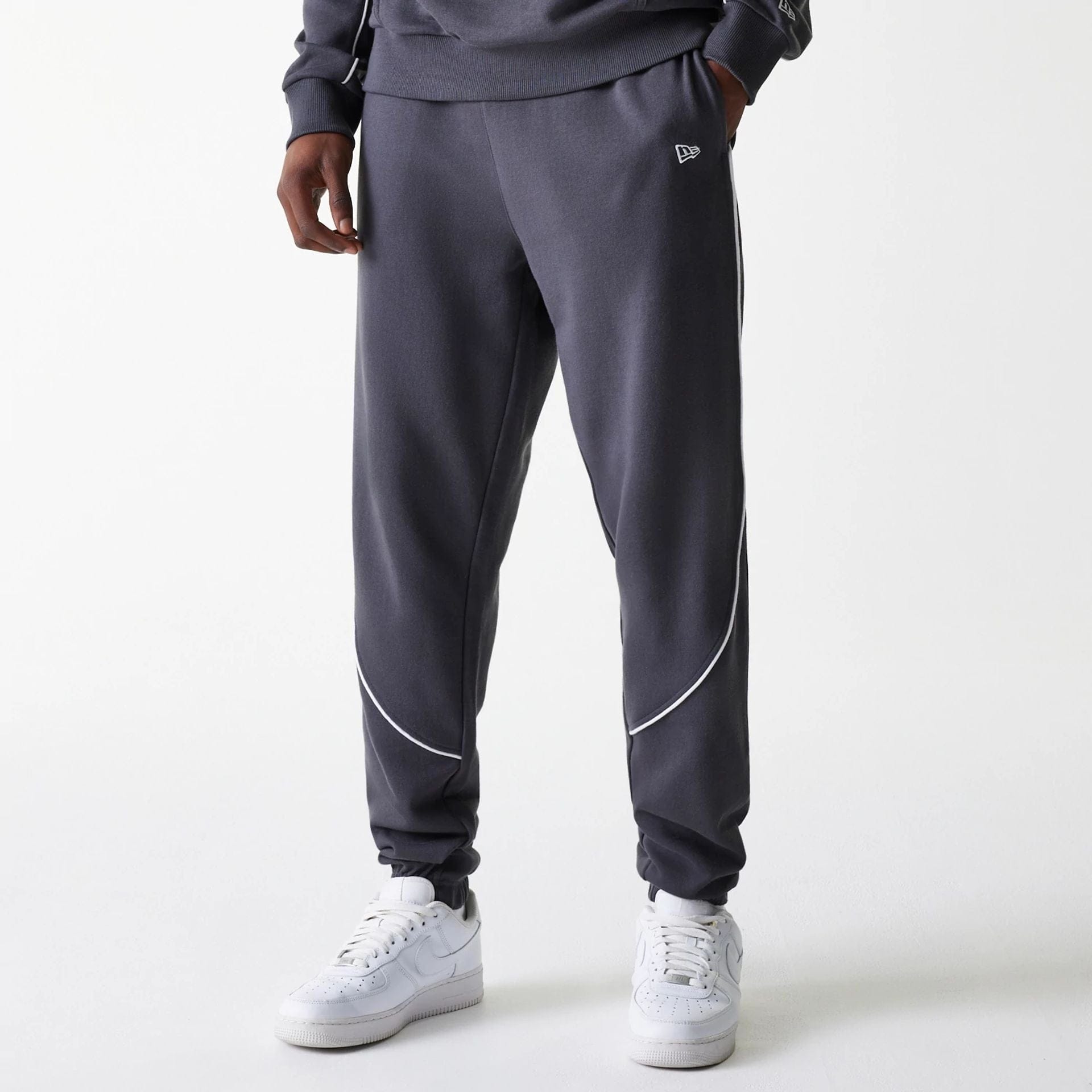 The Male model is wearing Boston Celtics NBA Piping Dark Grey Joggers 1