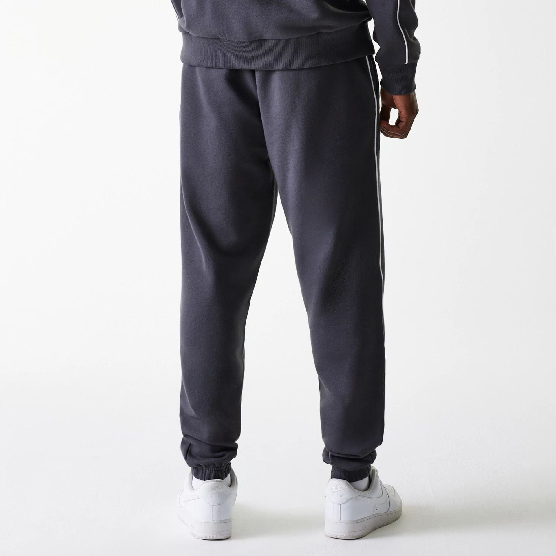 The Male model is wearing Boston Celtics NBA Piping Dark Grey Joggers 2