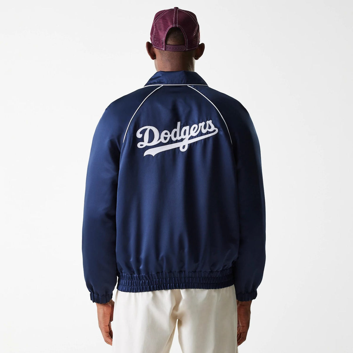 New Era LA Dodgers MLB Navy Club Jacket, rear view showing the embroidered white Dodgers script logo across the upper back, contrasted against the navy fabric, with white piping detail along the raglan sleeves.