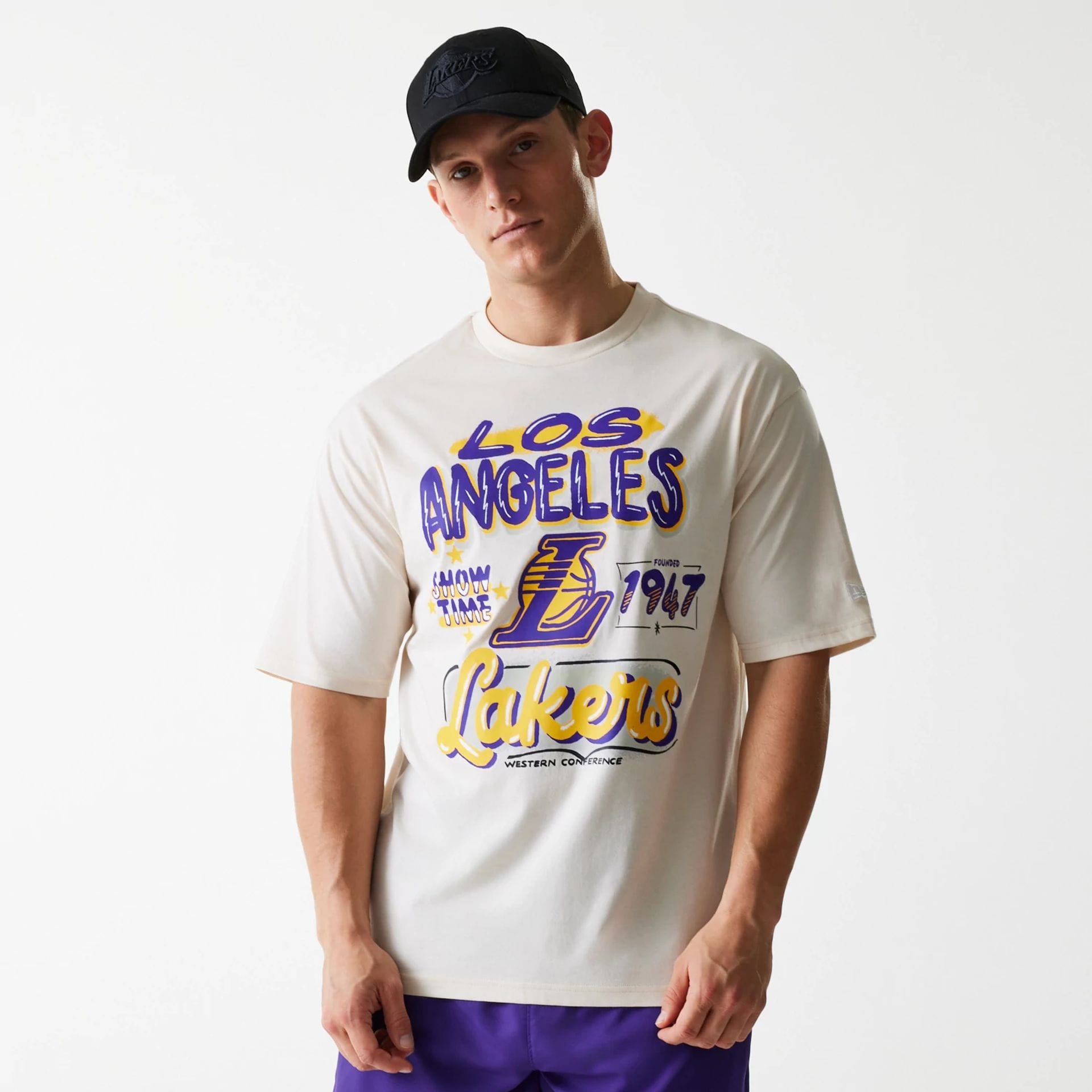 The Male model is wearing LA Lakers NBA Graphic Light Beige Oversized T-Shirt 1