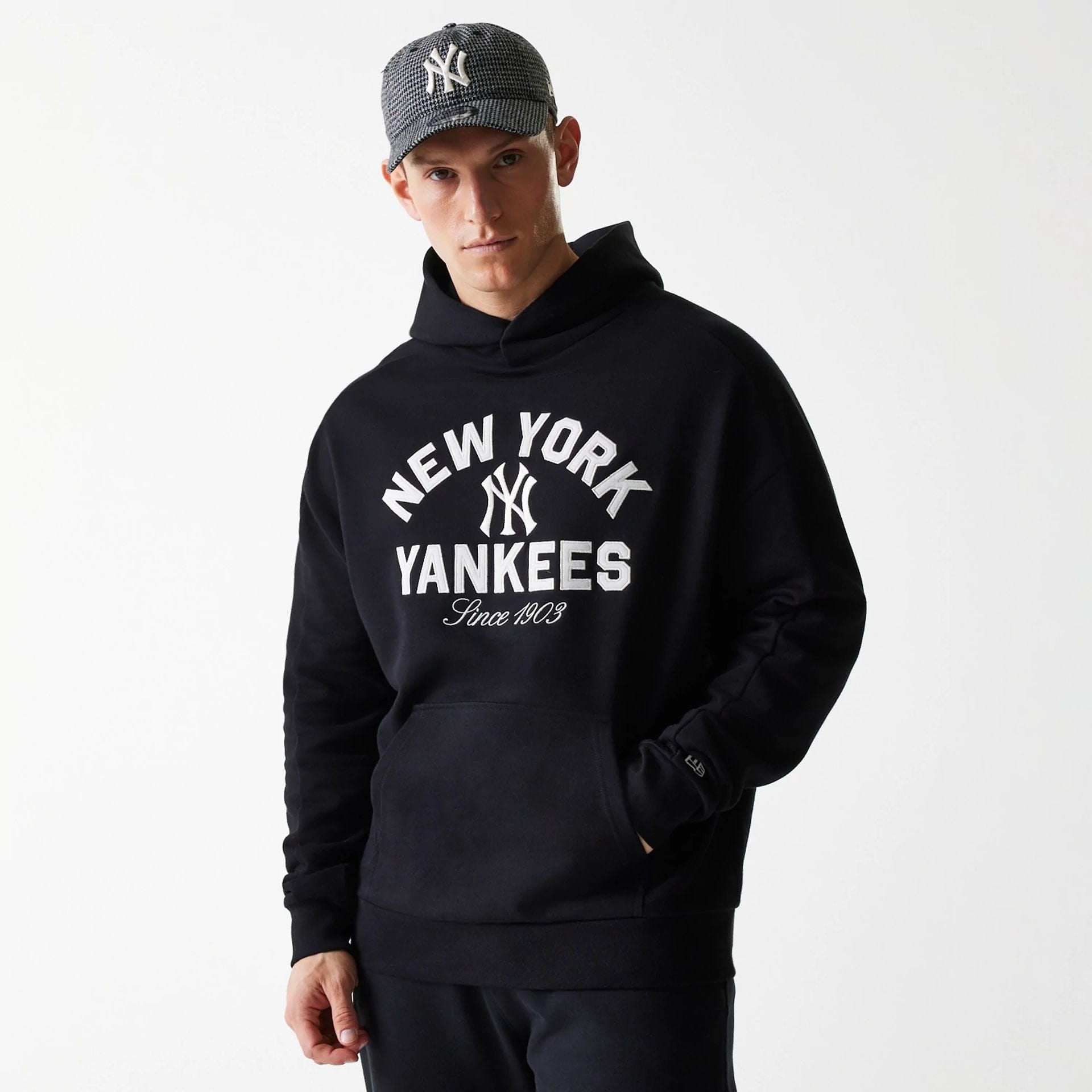 The Male model is wearing New York Yankees MLB Heritage Black Oversized Pullover Hoodie 1