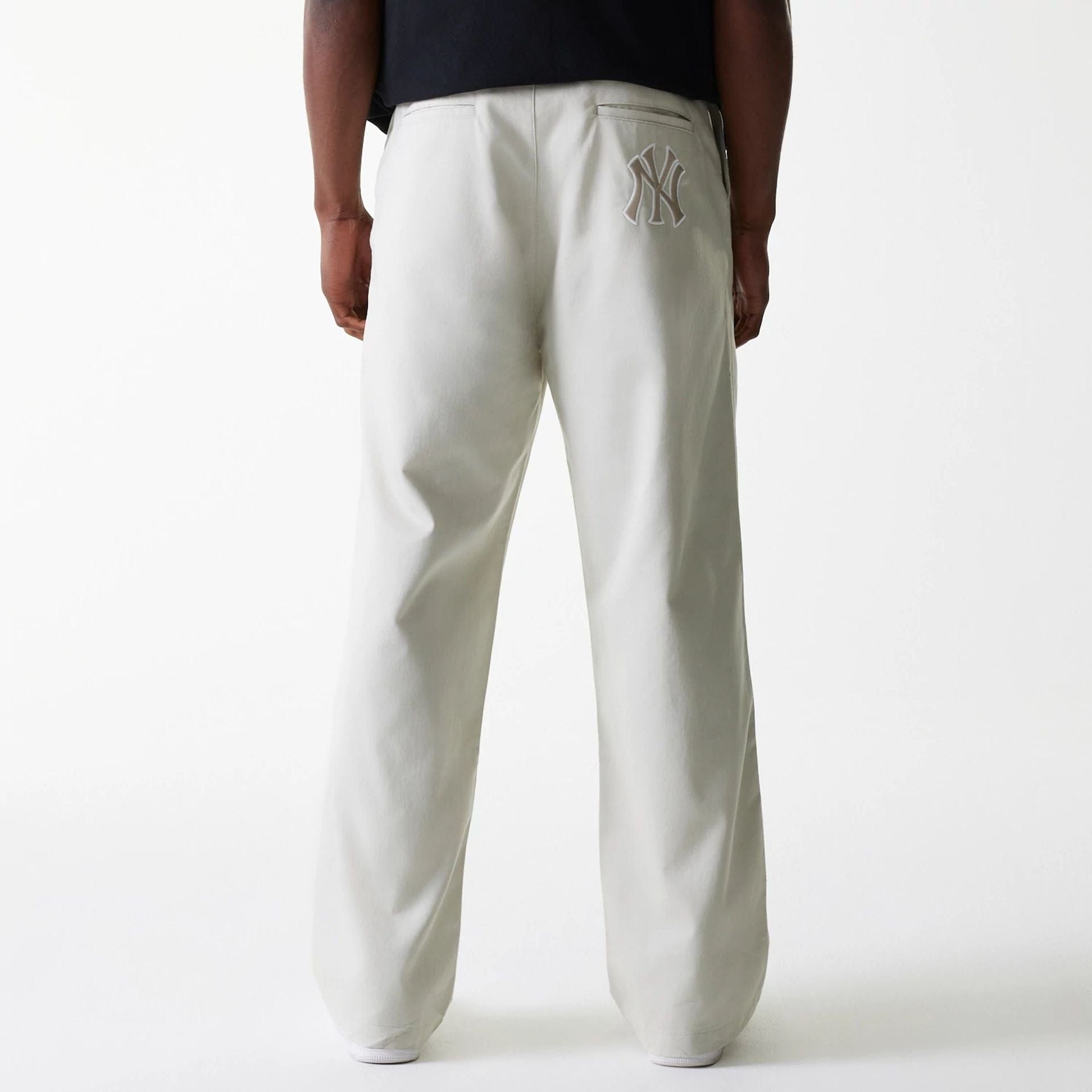 The Male model is wearing New York Yankees MLB Light Beige Chino Trousers 2