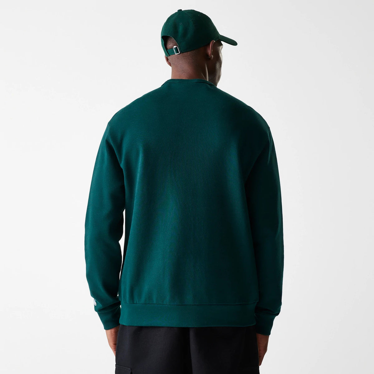 New Era Detroit Tigers MLB Heritage Dark Green Oversized Crew Neck Sweater, back view on a model in matching cap and black shorts, showing the relaxed fit and the ribbed hem and cuffs.
