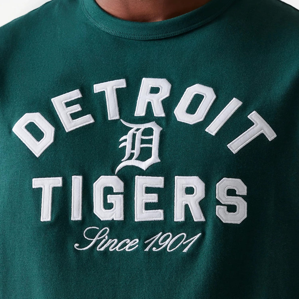 New Era Detroit Tigers MLB Heritage Dark Green Oversized T-Shirt, front view showing large white raised lettering with 'Detroit Tigers' and an interlocking 'D' in the centre, set on a dark green background.