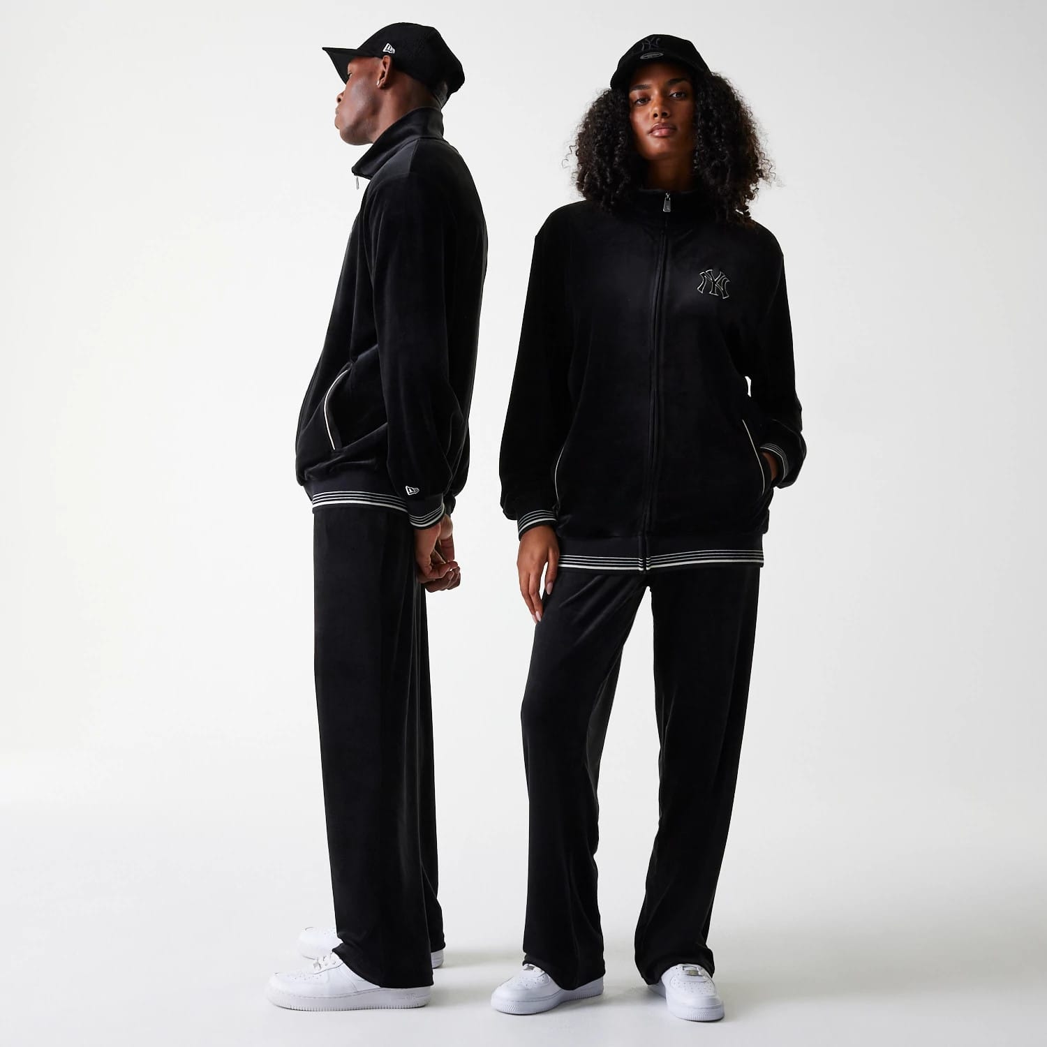 The Male model is wearing New York Yankees MLB Velour Black Track Pants 1
