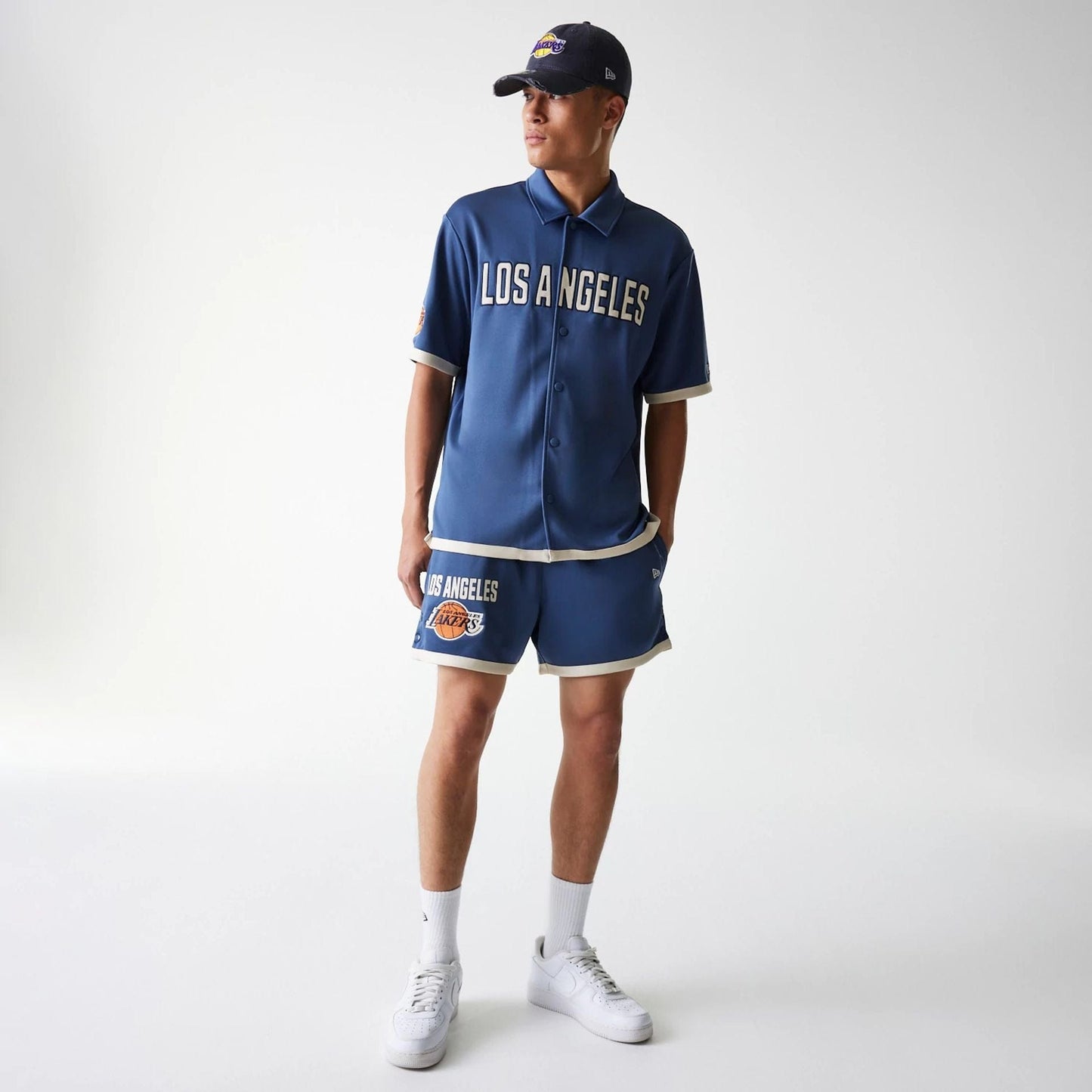 The Male model is wearing LA Lakers NBA Snap Button Dark Blue Shorts 8