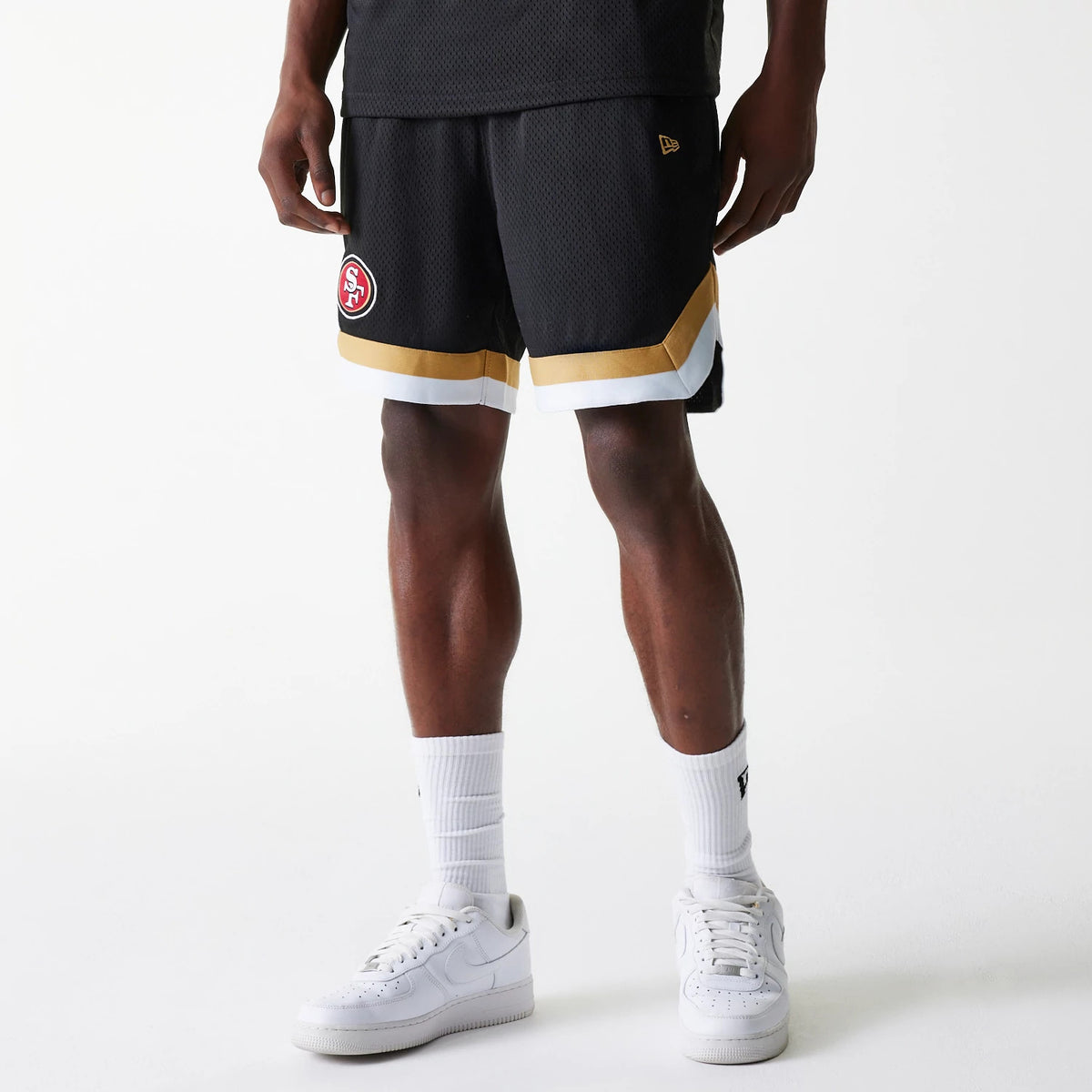 New Era San Francisco 49ers NFL Mesh Black Shorts, front view showing an embroidered team logo on the right leg, gold and white trim along the hem, and a raised New Era logo on the left side.