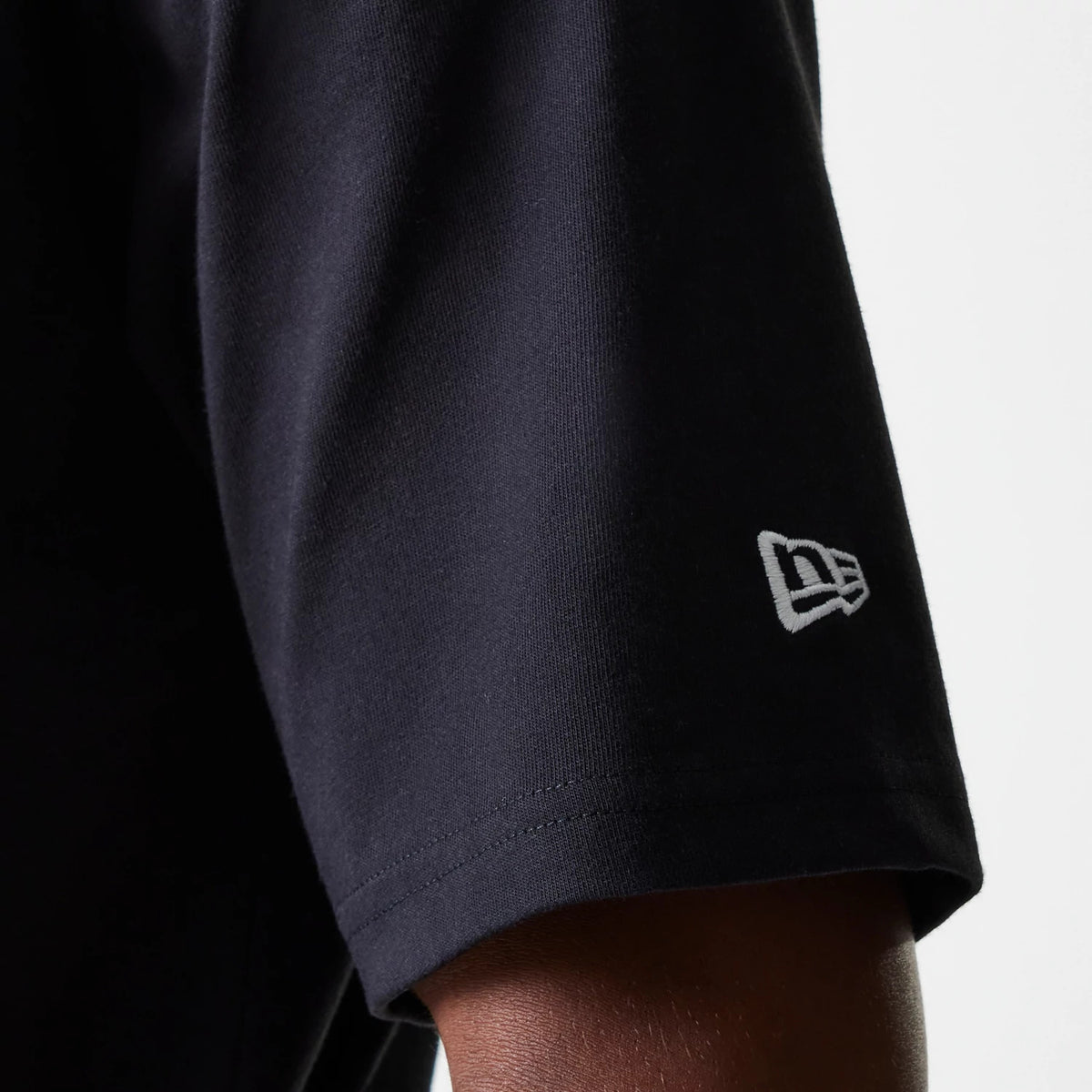 The Male model is wearing New Era Graphic Black Oversized T-Shirt 7