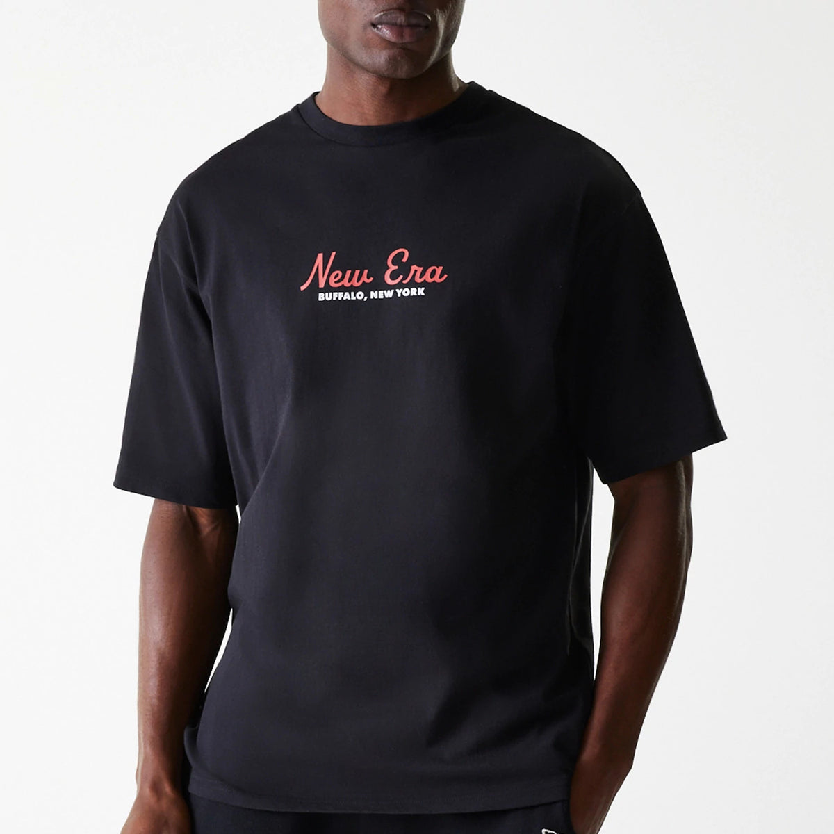 New Era Animal Graphic Black Oversized T-Shirt, front view showing a black T-shirt with a red and white printed New Era logo and Buffalo, New York text across the chest, featuring short sleeves and a relaxed fit.