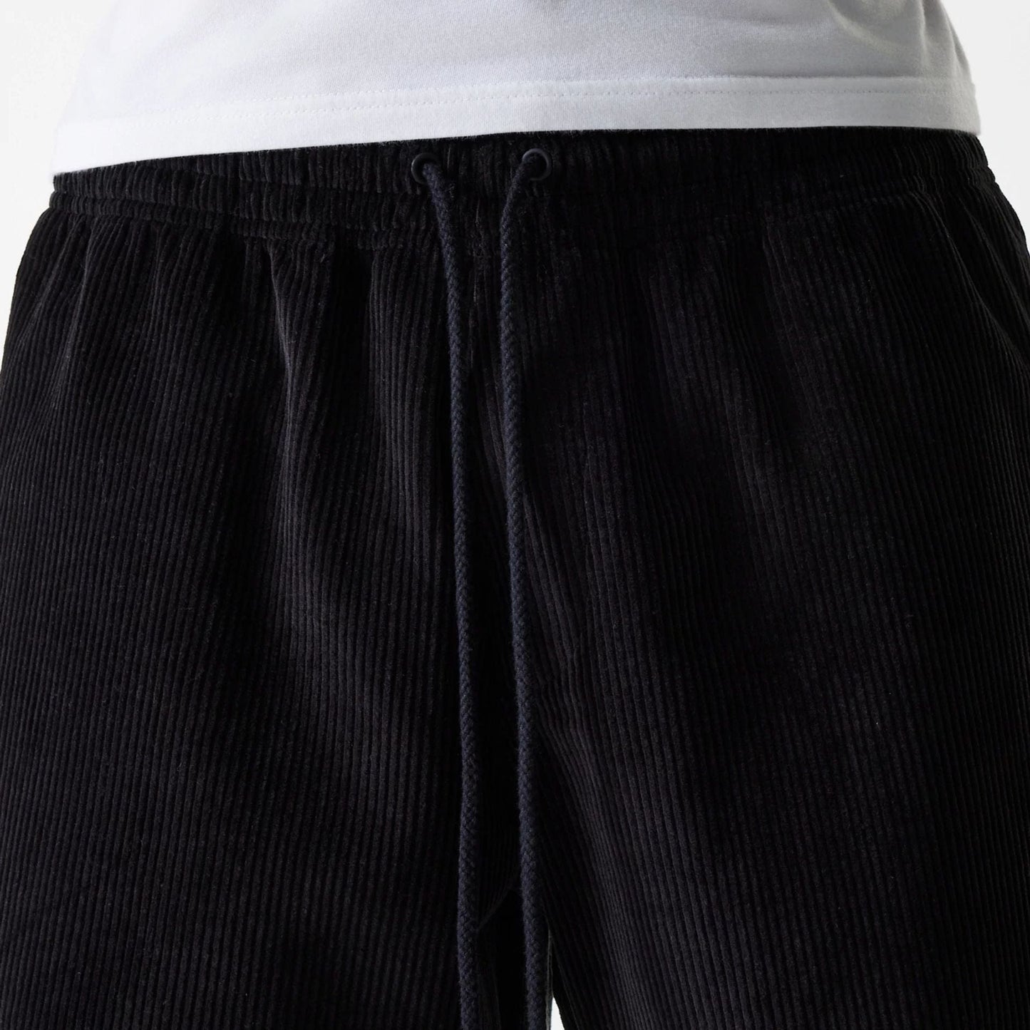 The Male model is wearing New Era Cord Black Shorts 5
