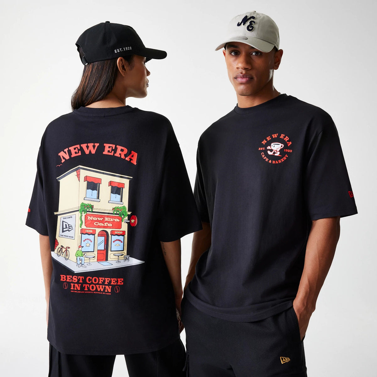 New Era Cafe Graphic Black Oversized T-Shirt, front and rear view showing a small red circular logo with a coffee cup on the chest, and a large colourful cafe graphic with 'New Era' text on the back.