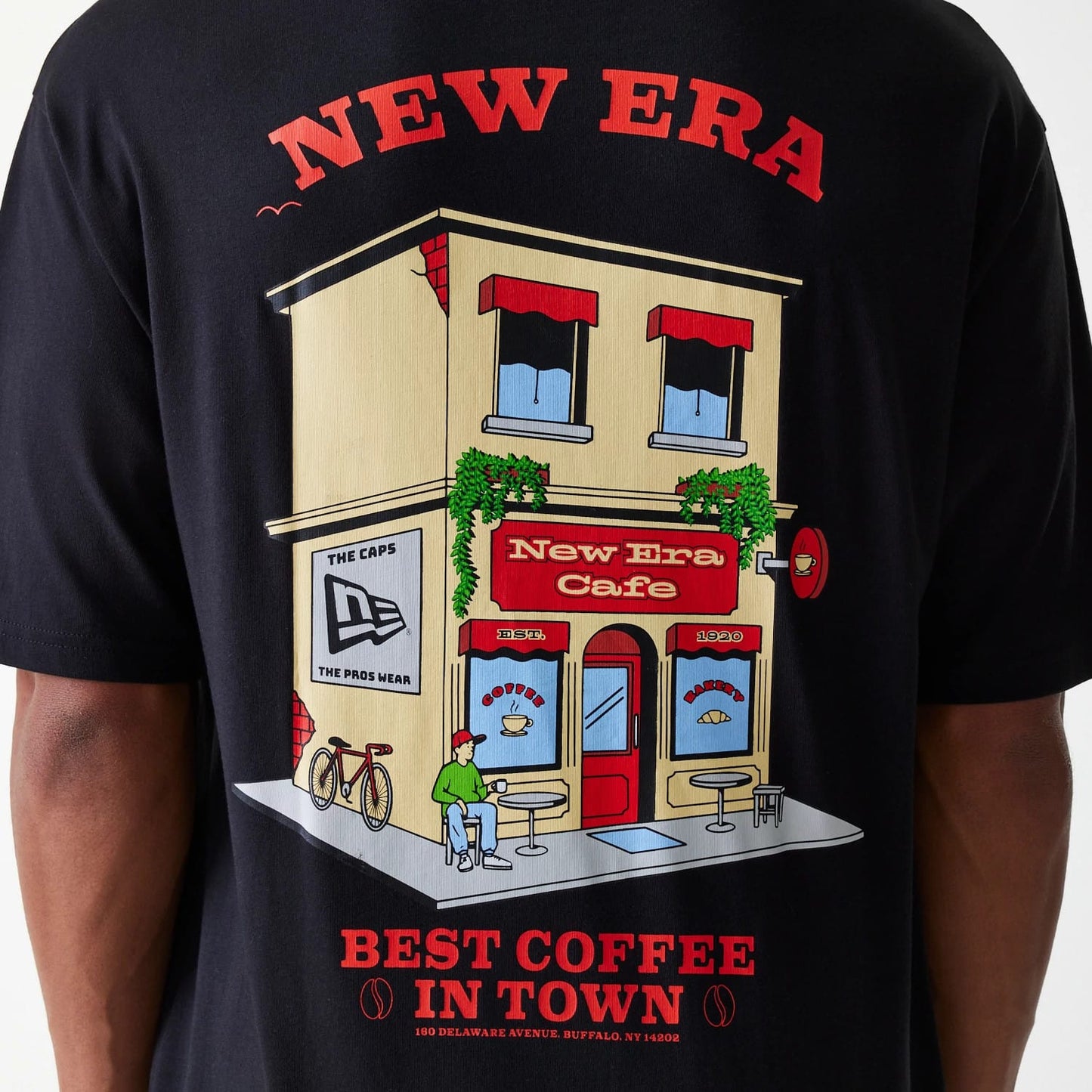 The Male model is wearing New Era Cafe Graphic Black Oversized T-Shirt 8