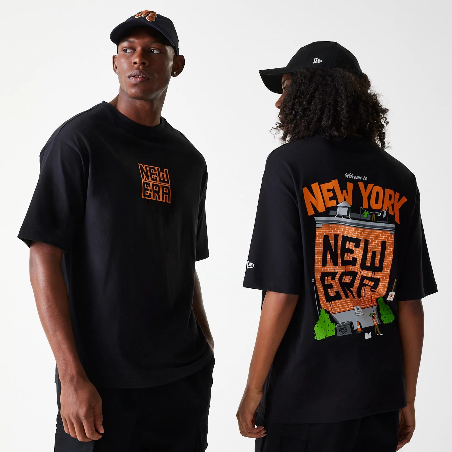 New Era Graffiti Graphic Black Oversized T-Shirt, on-model view showing the front with an orange graffiti-style logo centred on the chest, and the back featuring a large New York themed graffiti graphic spanning the entire back.