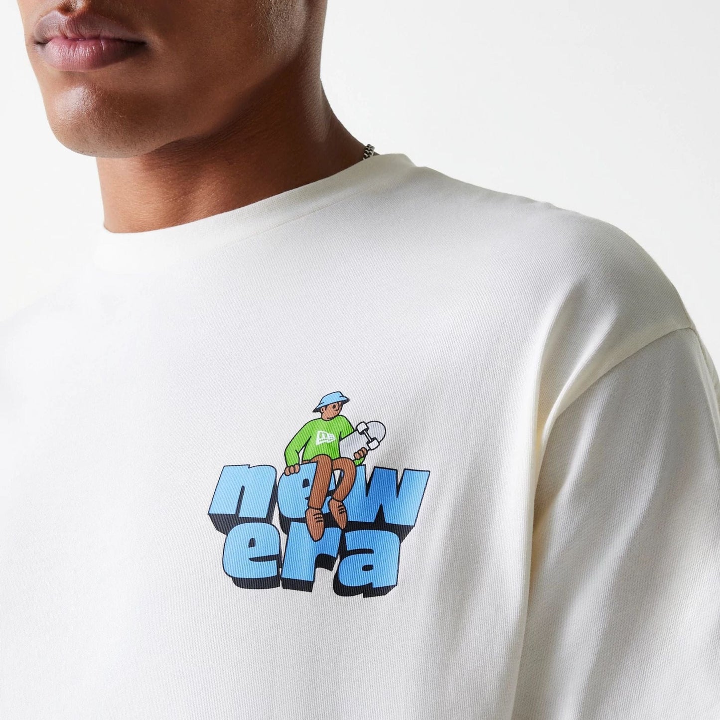 The Male model is wearing New Era Skate Graphic Open White Oversized T-Shirt 8