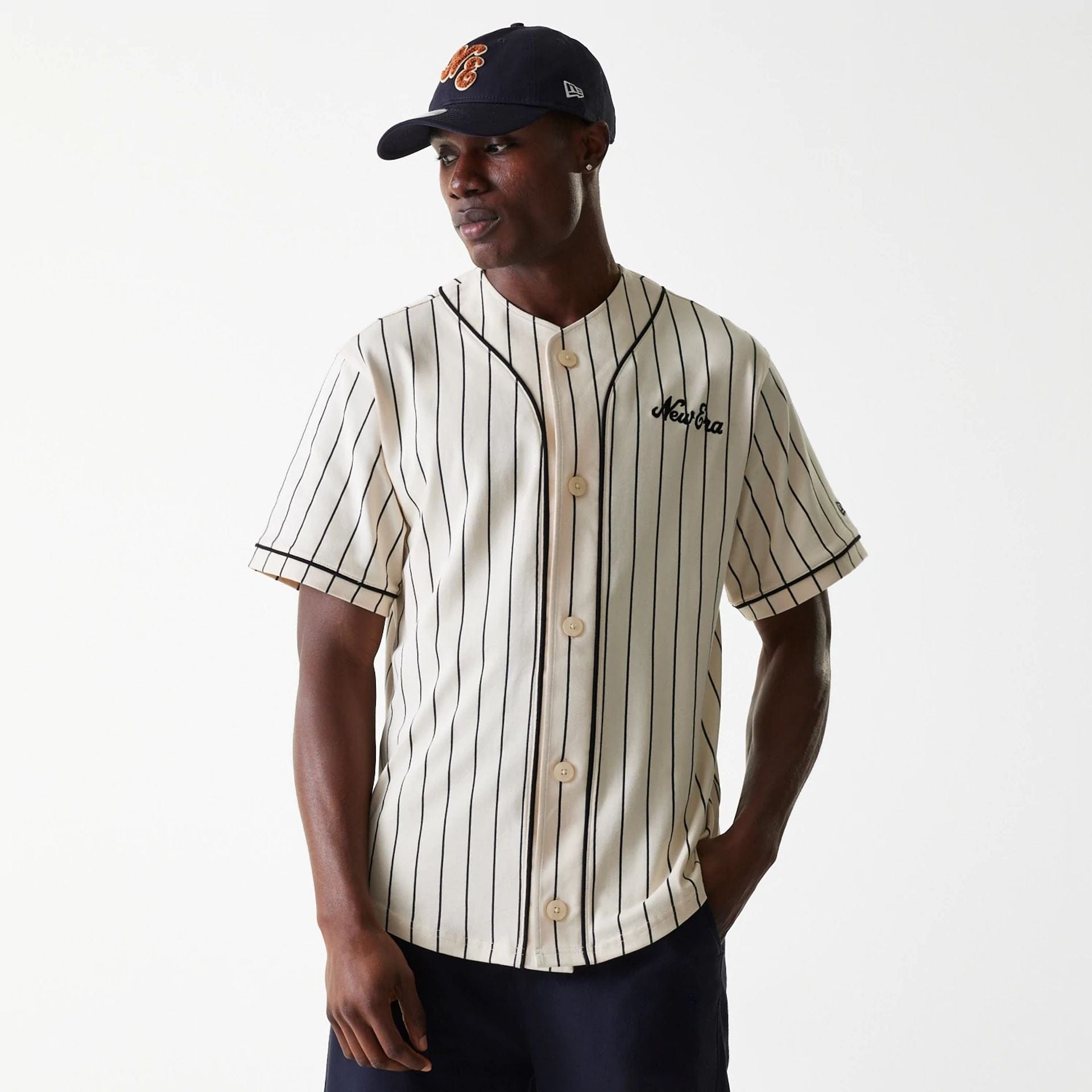 The Male model is wearing New Era Pinstripe Light Beige Jersey 1