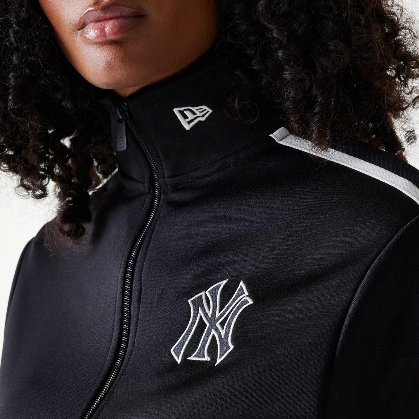 New Era New York Yankees Womens MLB Midi Logo Black Track Jacket, front view showing the raised white New York Yankees logo on the chest, a zip running through the centre, and a raised white New Era logo on the black collar.