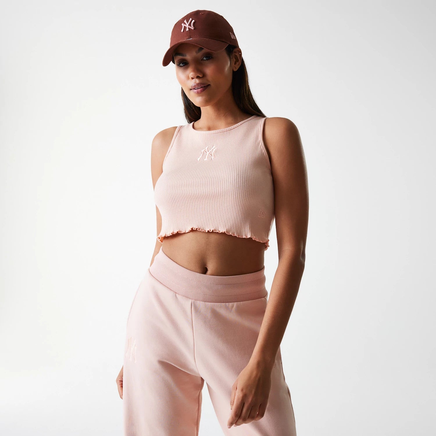 The Female model is wearing New York Yankees Womens MLB Rib Pastel Pink Rib Tank Top 1