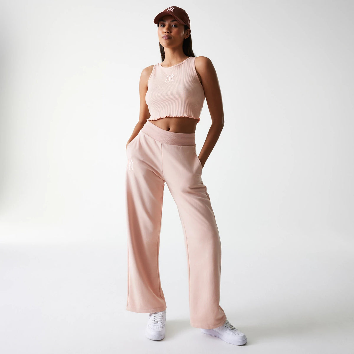New Era New York Yankees Womens MLB Rib Pastel Pink Rib Tank Top, on-model view styled with matching pastel pink trousers featuring the NY logo, showcasing the ribbed texture and cropped design.