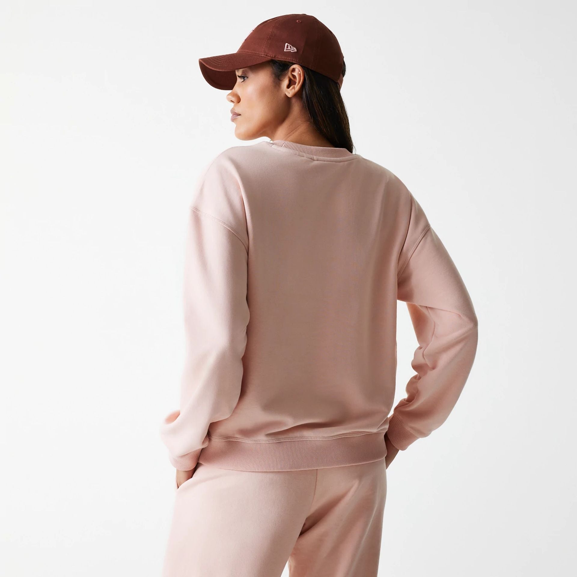 The Female model is wearing New York Yankees Womens MLB Tonal Graphic Pastel Pink Oversized Crew Neck Sweater 2