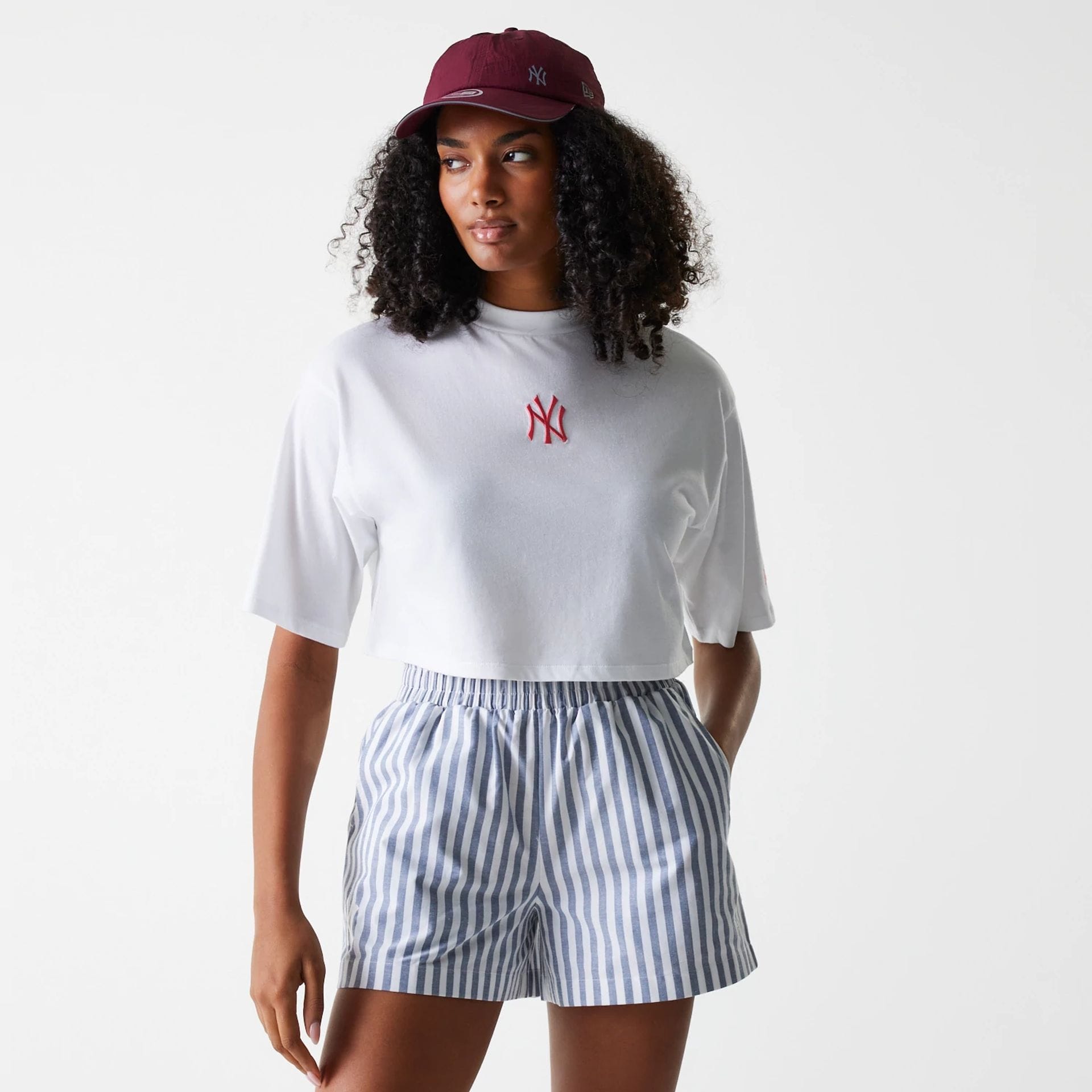 The Female model is wearing New York Yankees Womens MLB Stripe Dark Blue Shorts 1