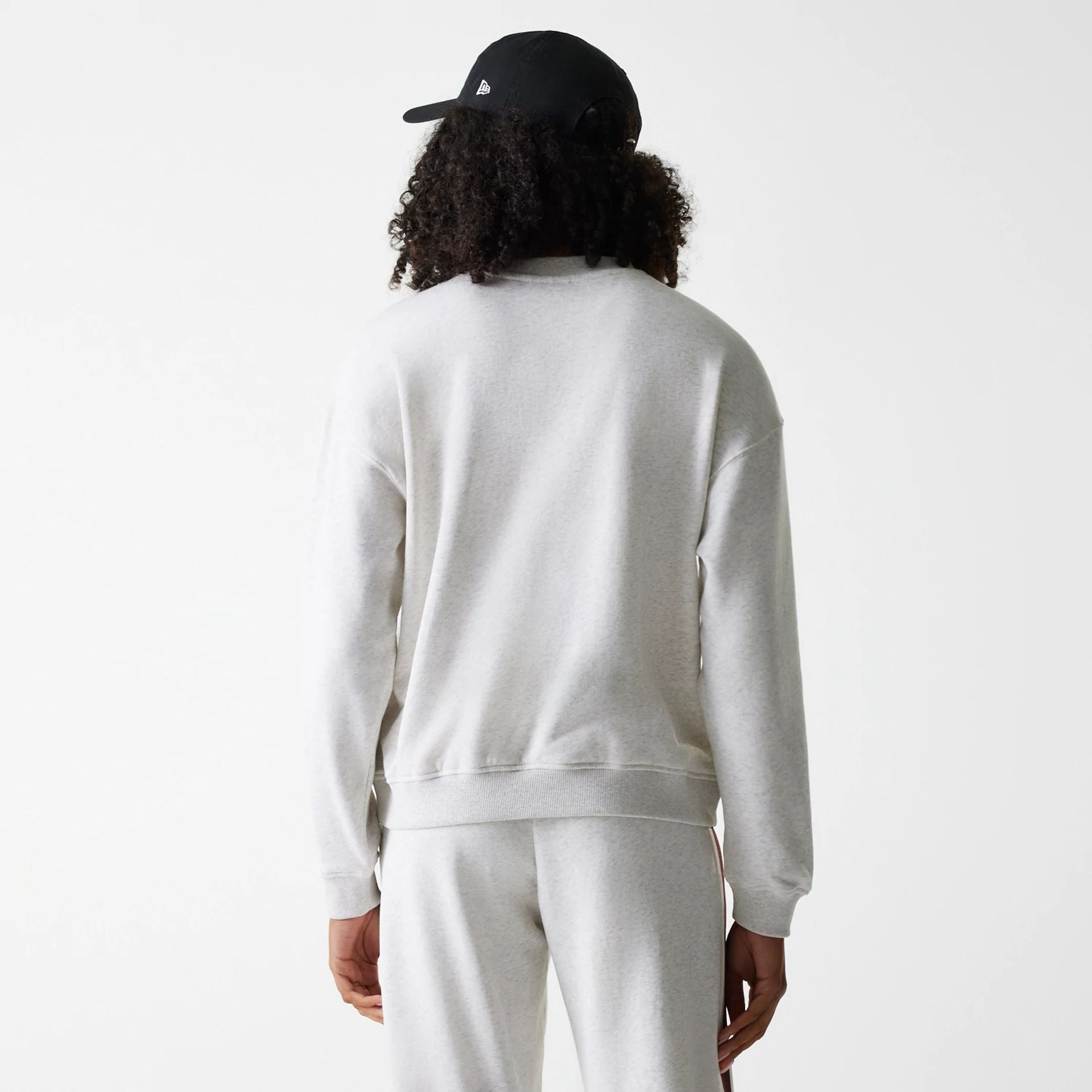 The Female model is wearing Womens New Era Crest Graphic Pastel Grey Crew Neck Sweater 2