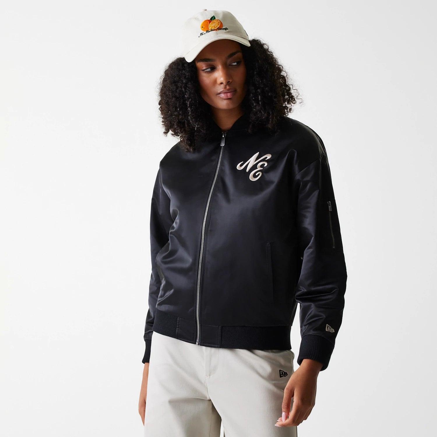 The Female model is wearing Womens New Era Satin Black Satin Bomber Jacket 1