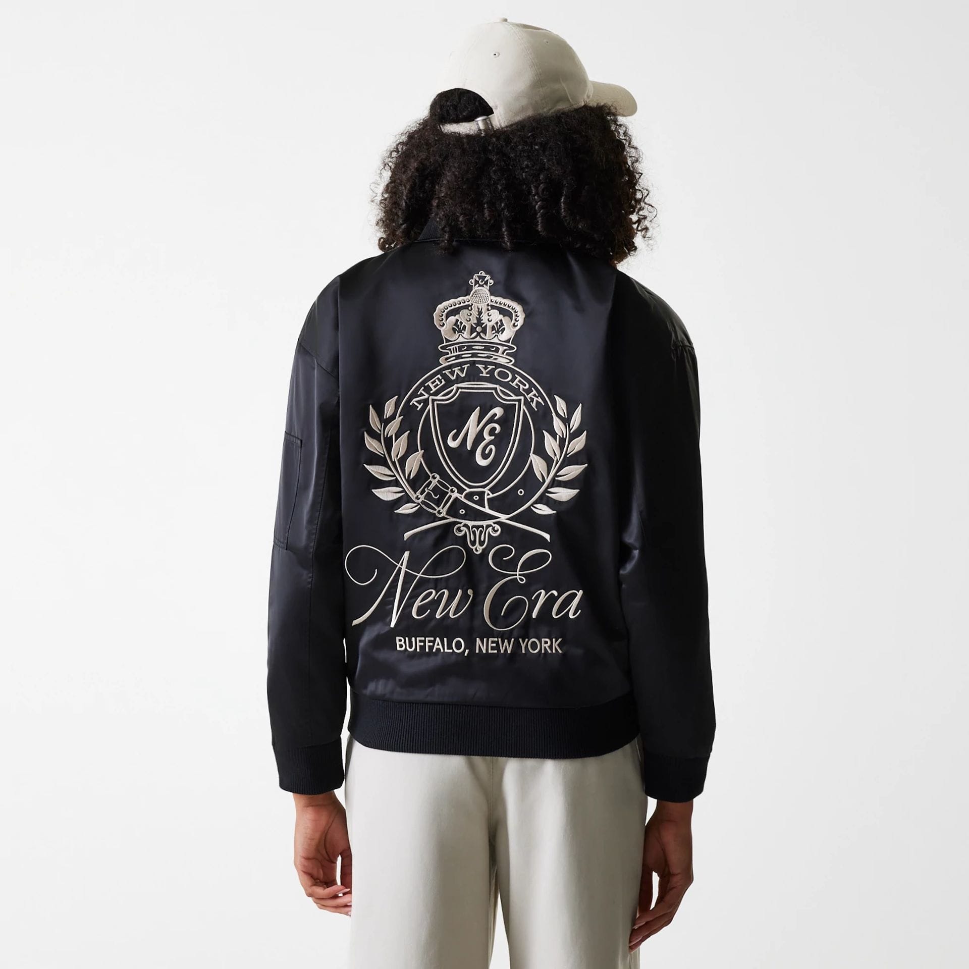 The Female model is wearing Womens New Era Satin Black Satin Bomber Jacket 2