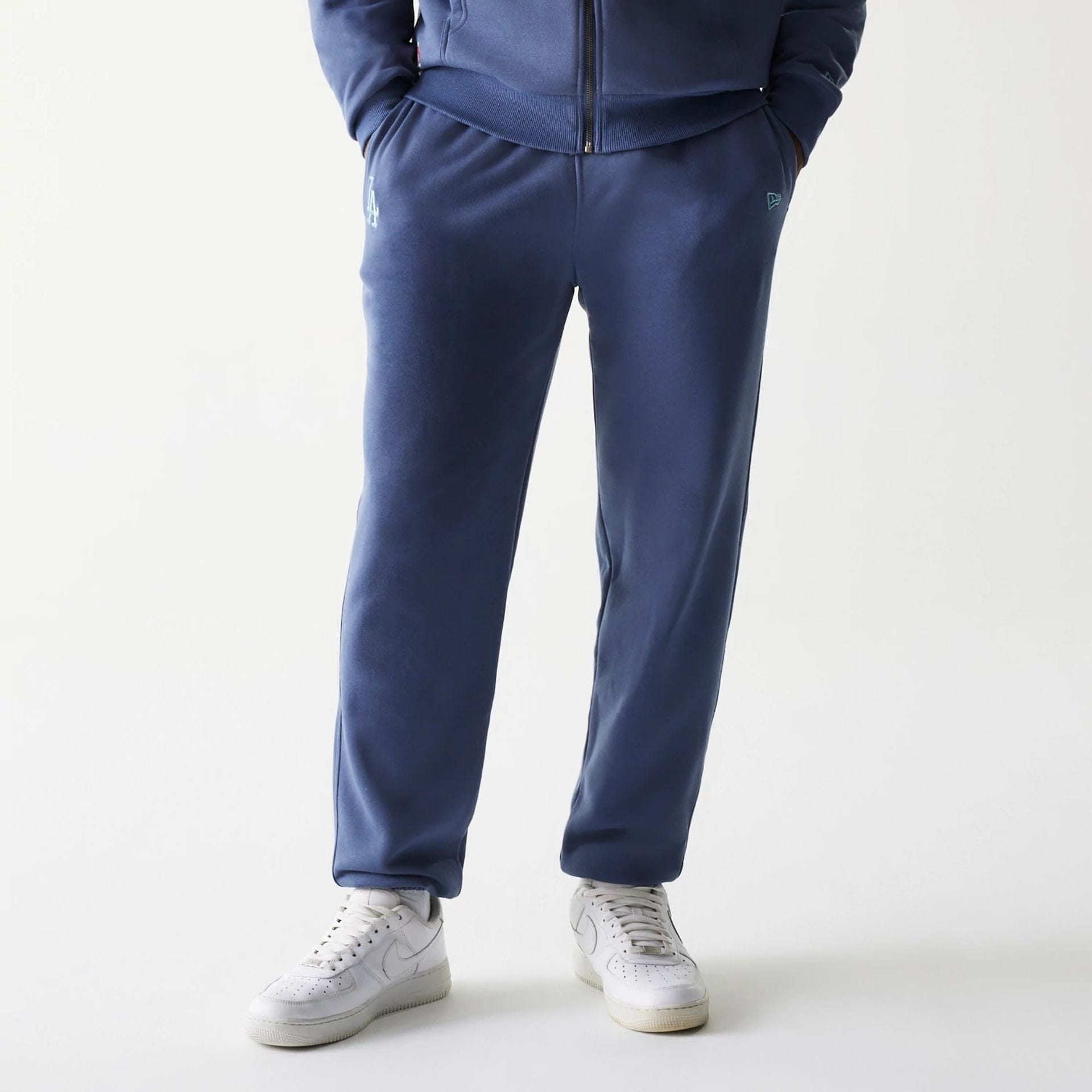 The Male model is wearing LA Dodgers MLB Midi League Essential Dark Blue Joggers 1