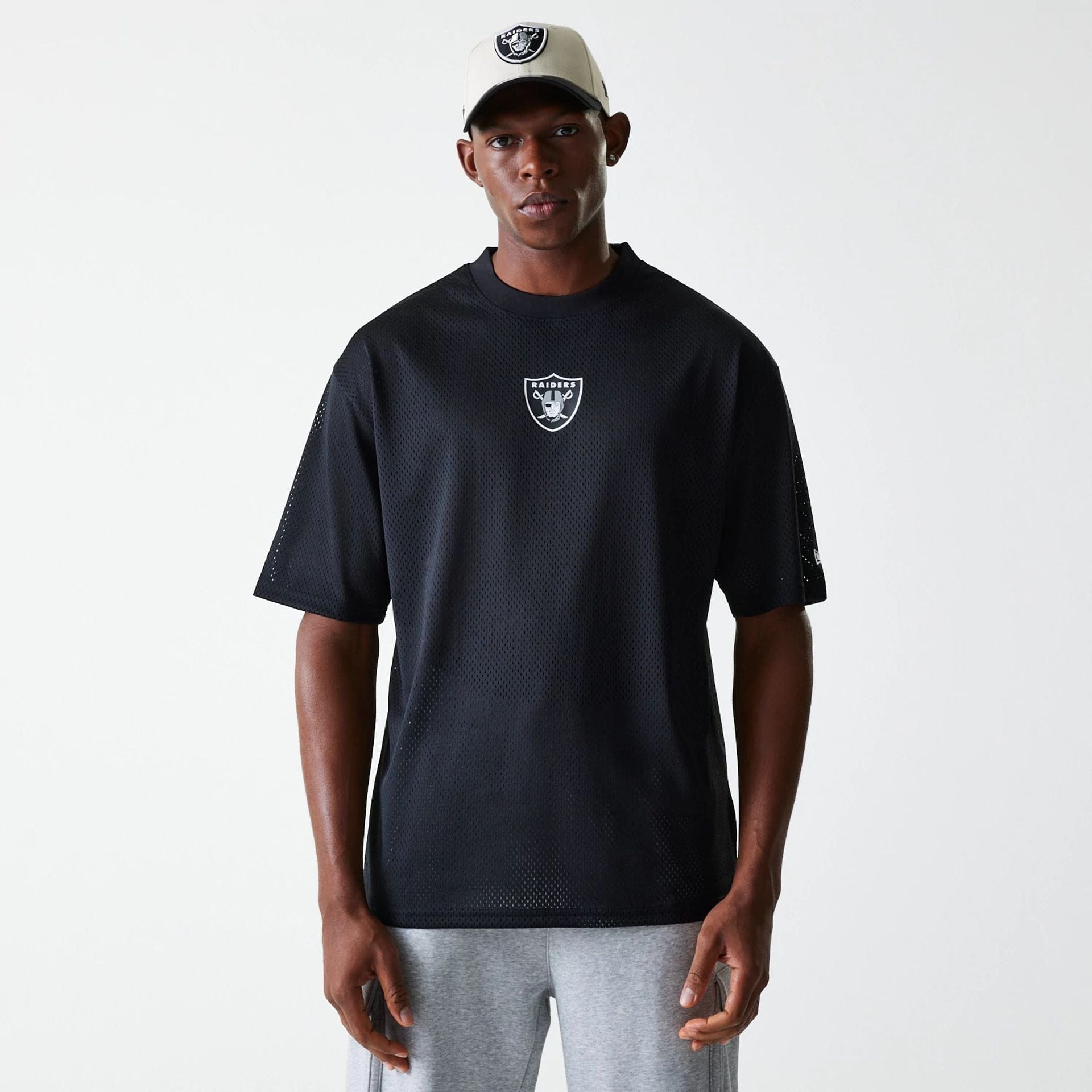 The Male model is wearing Las Vegas Raiders NFL Essentials Black Oversized Mesh T-Shirt 1