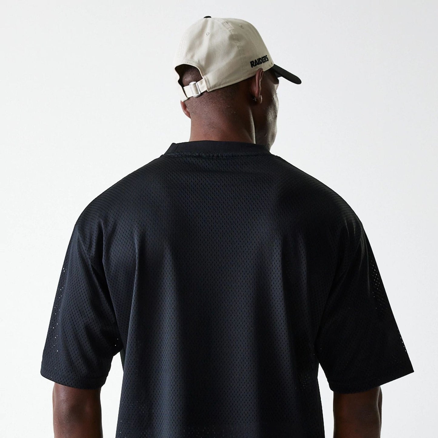 The Male model is wearing Las Vegas Raiders NFL Essentials Black Oversized Mesh T-Shirt 7