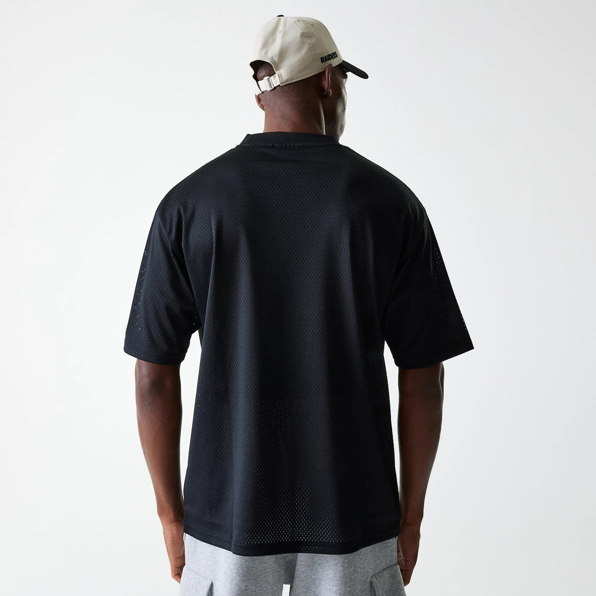 The Male model is wearing Las Vegas Raiders NFL Essentials Black Oversized Mesh T-Shirt 2