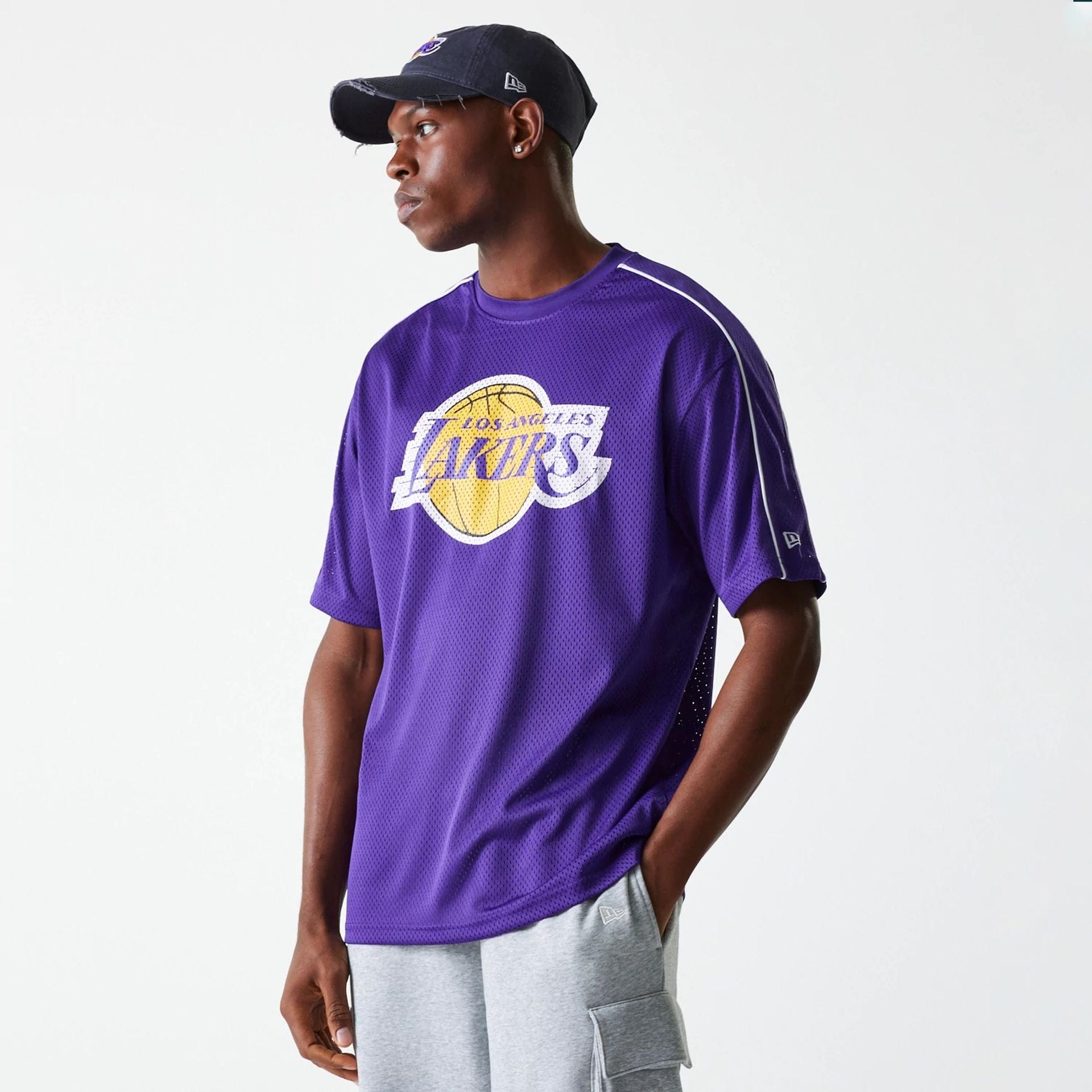 The Male model is wearing LA Lakers NBA Piping Purple Oversized Mesh T-Shirt 1