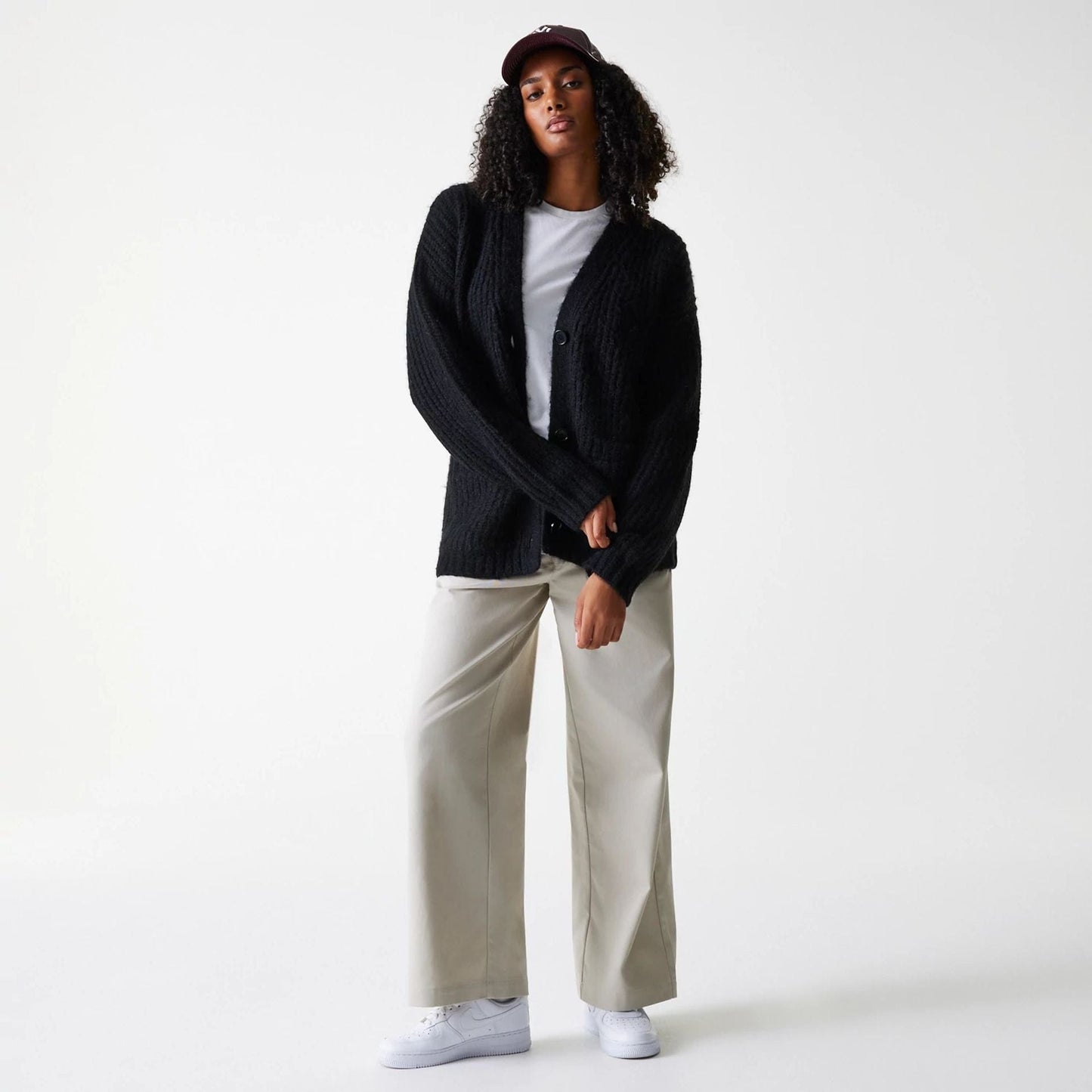 New Era New York Yankees Womens MLB Knit Black Cardigan, front view on a model with cream trousers and white sneakers, buttoned up over a white top, featuring a soft textured finish and a relaxed fit.