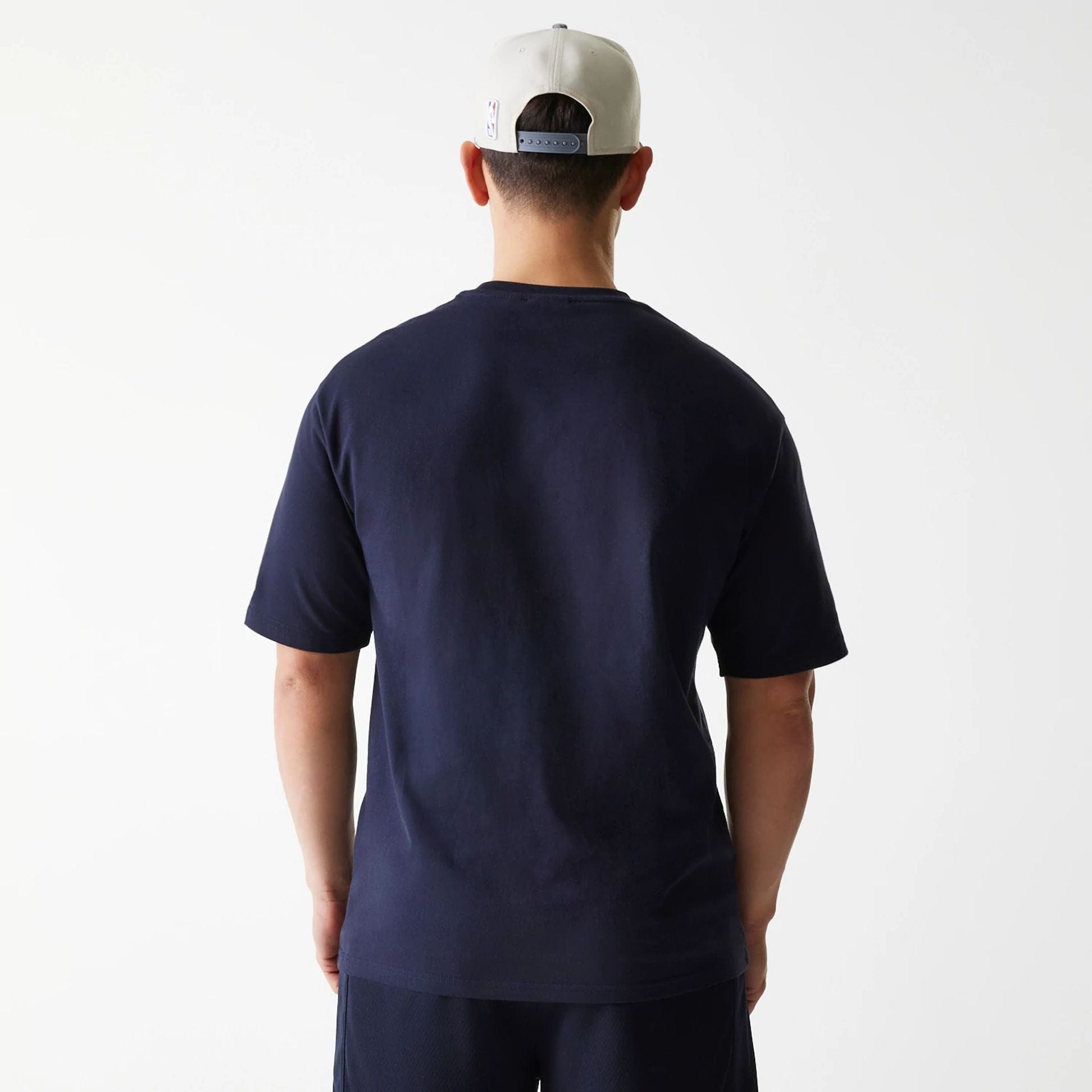 The Male model is wearing Boston Celtics NBA Arch Graphic Navy Oversized T-Shirt 2