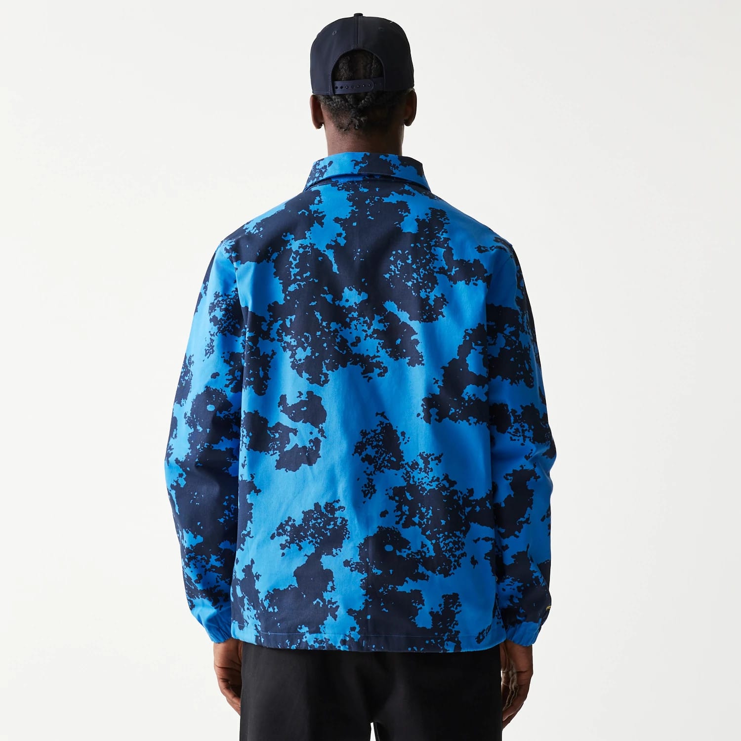 New Era Red Bull Racing Blue Oversized Coach Jacket, rear view showing the blue and black camo pattern across the back with a straight collar and elasticated cuffs.