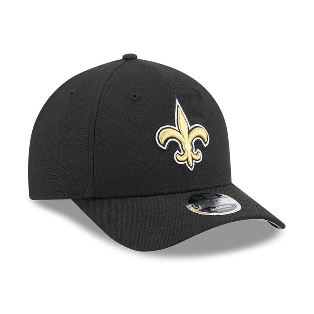 New Orleans Saints NFL Team Black New Era 9FORTY M-Crown Cap, front view showing the gold and white embroidered fleur-de-lis logo on the front panel, with a curved visor and a 9FORTY size sticker on top.