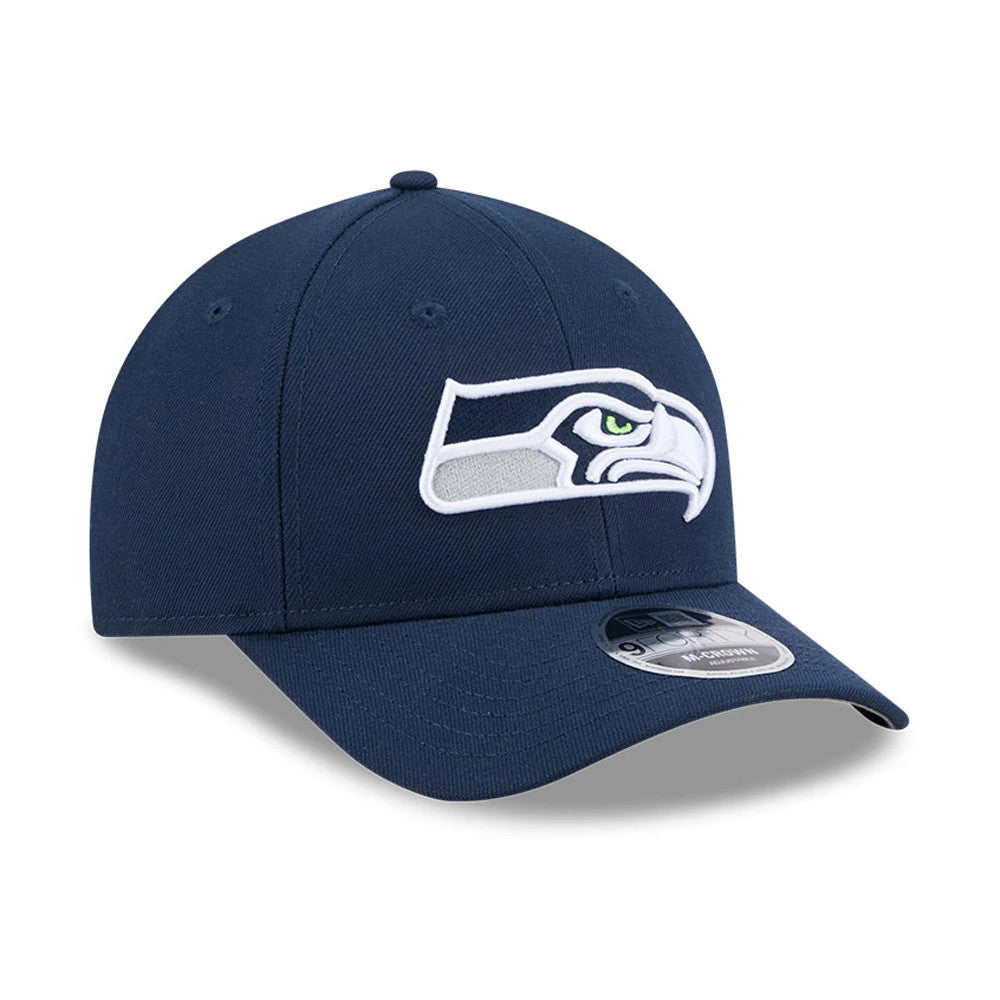 Seattle Seahawks NFL Team Dark Blue New Era 9FORTY M-Crown Cap, three-quarter view showing the white and grey embroidered Seahawks logo on the front panel, with a curved visor and the 9FORTY size sticker on top.