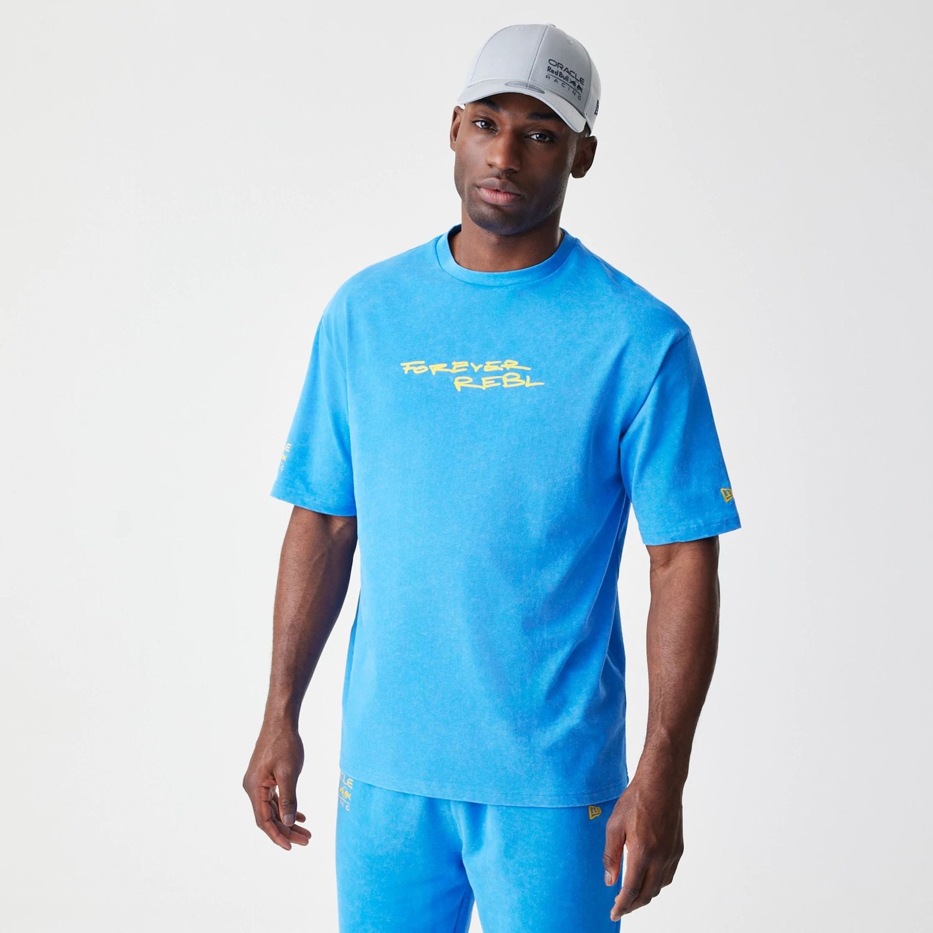 The Male model is wearing Red Bull Racing Back Graphic Blue Oversized T-Shirt 1