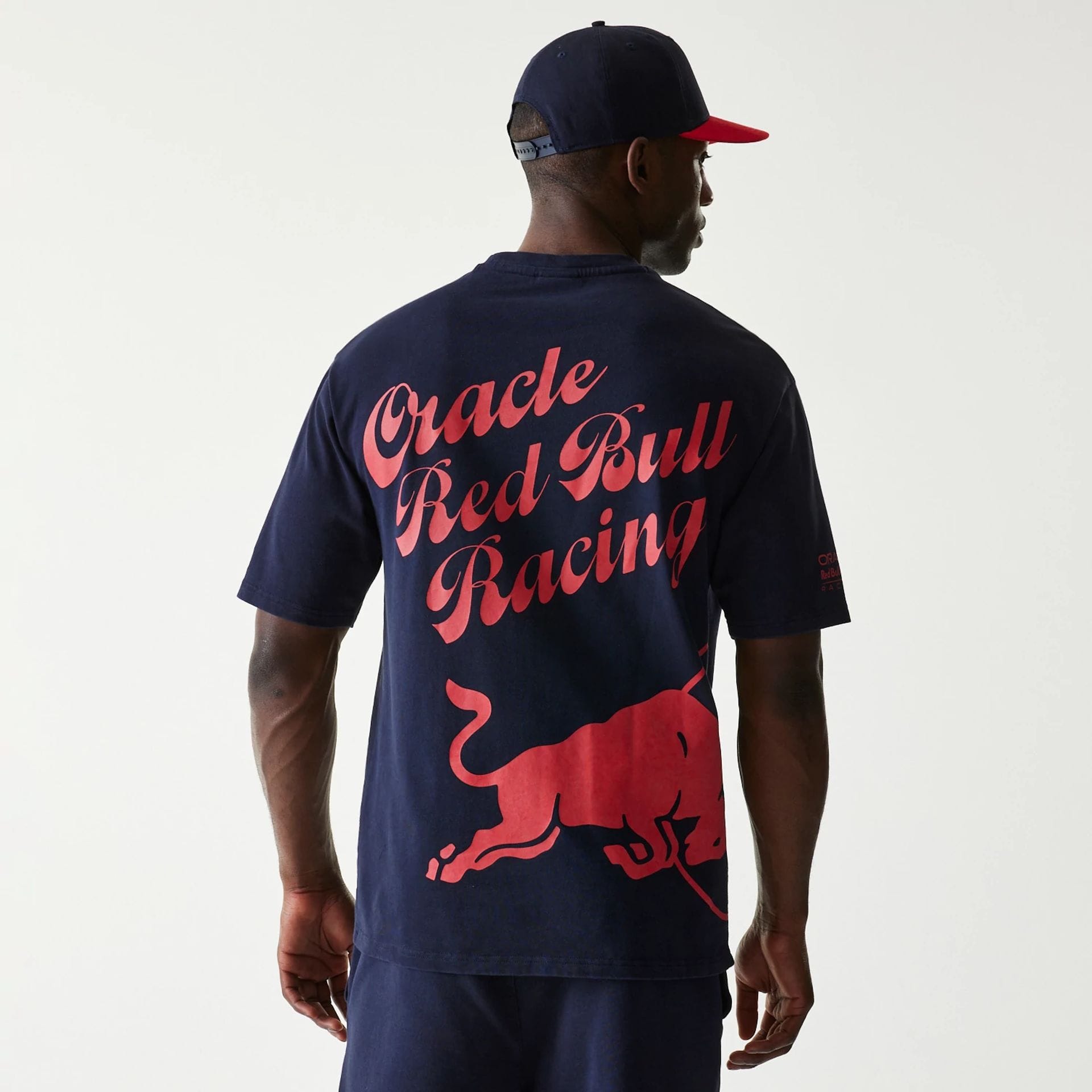 The Male model is wearing Red Bull Racing Back Graphic Dark Blue Oversized T-Shirt 2