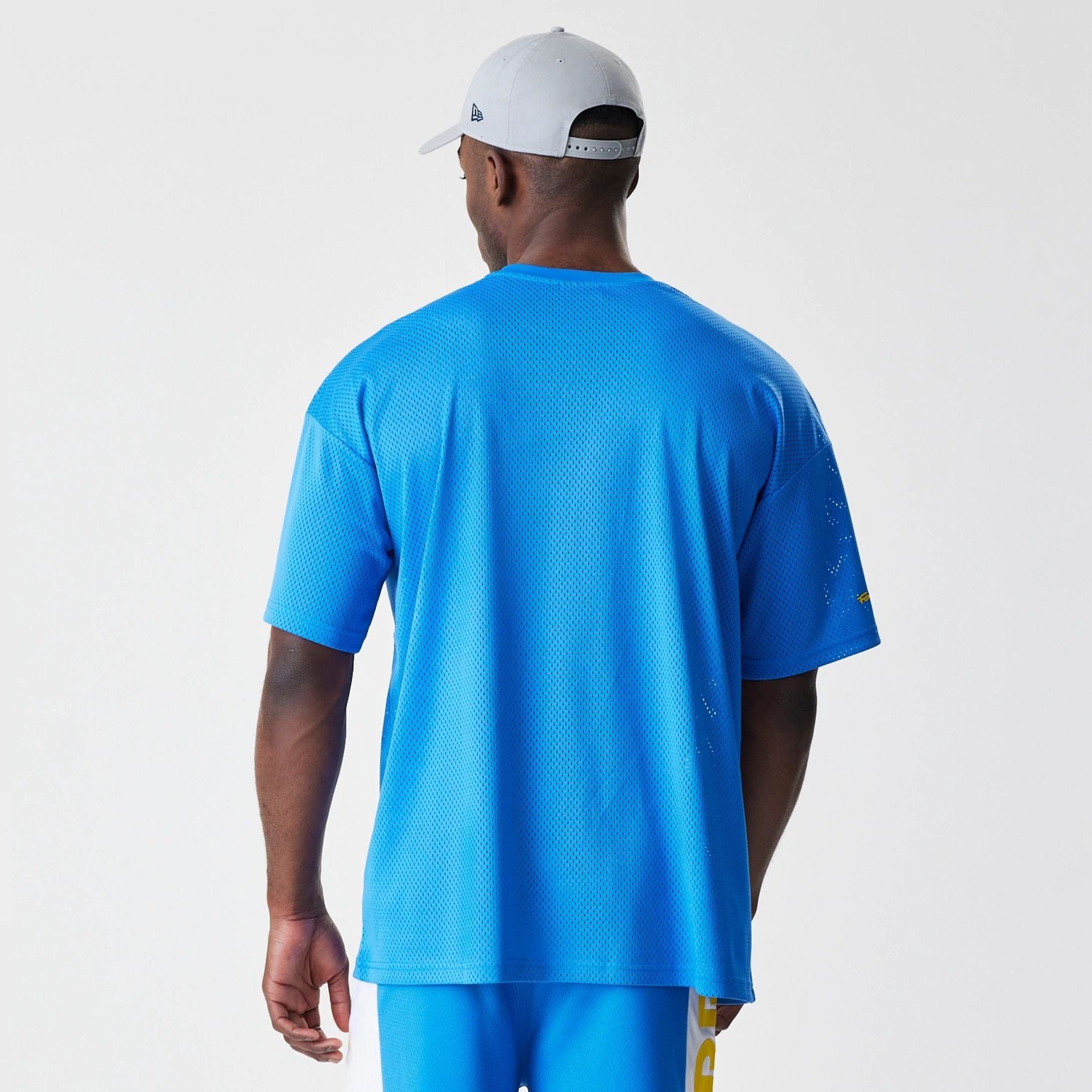 The Male model is wearing Red Bull Racing Graphic Mesh Blue Oversized T-Shirt 2