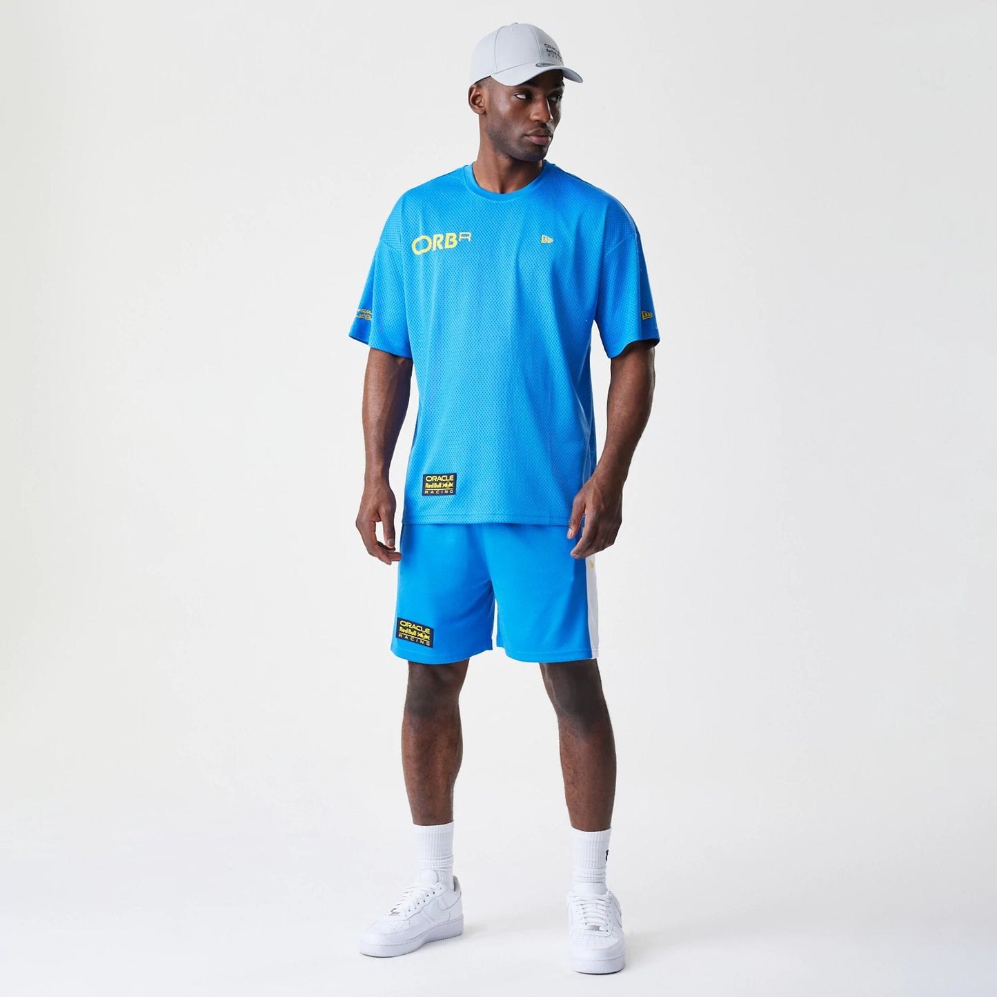 The Male model is wearing Red Bull Racing Graphic Mesh Blue Oversized T-Shirt 8
