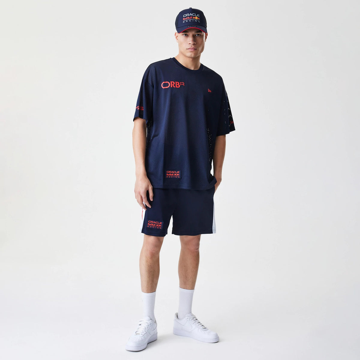 The Male model is wearing Red Bull Racing Graphic Mesh Dark Blue Oversized T-Shirt 8