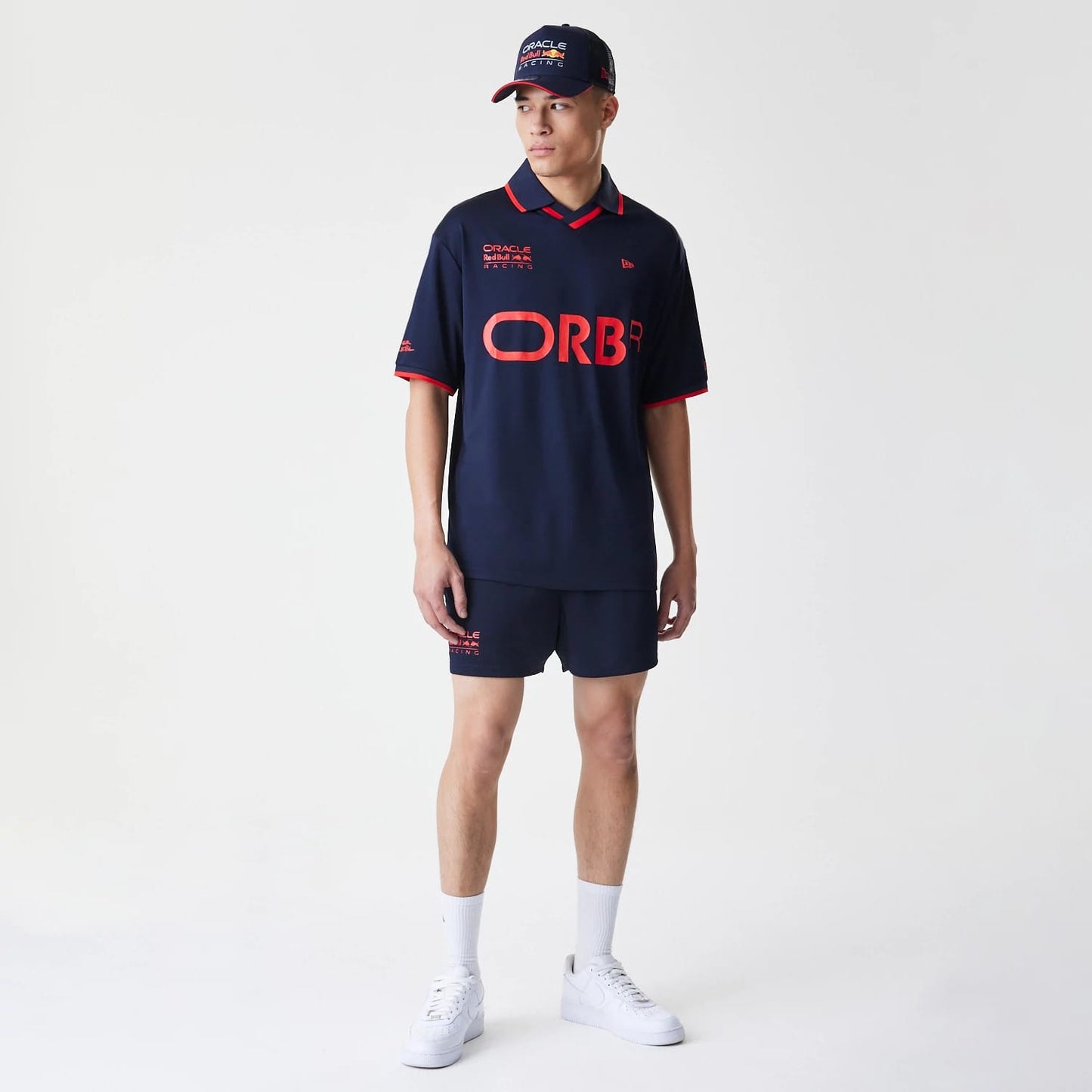 The Male model is wearing Red Bull Racing Graphic Dark Blue Football Shorts 8